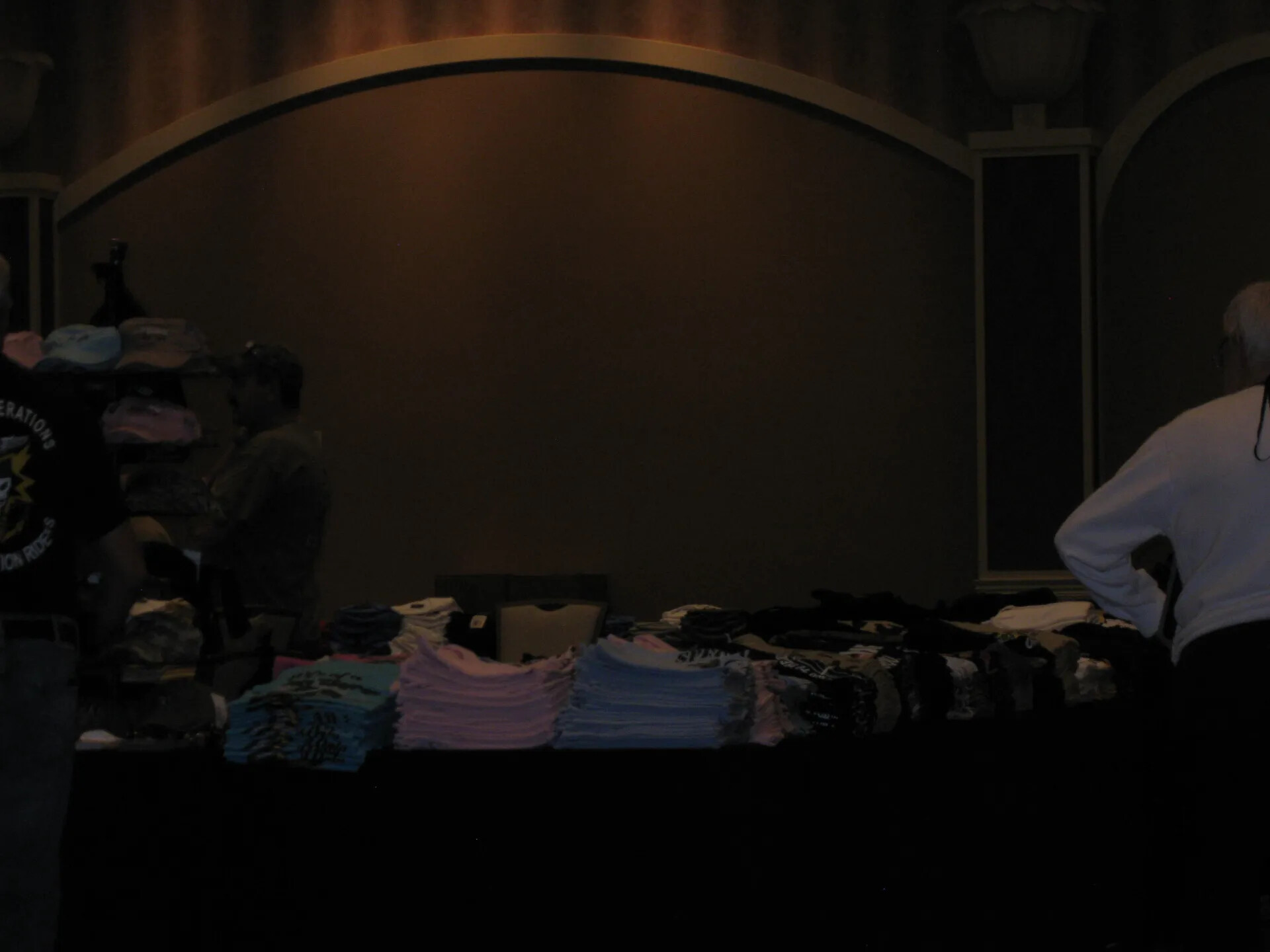 Souvenir Apparel Vendor Table in the Darkened Ballroom, SOAR XXXVII, Las Vegas, 2013 (underexposed)
