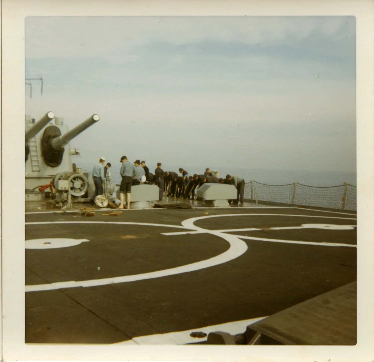 Deck Maintenance Detail on Helicopter Landing Pad, USS Saint Paul (CA-73), circa 1970