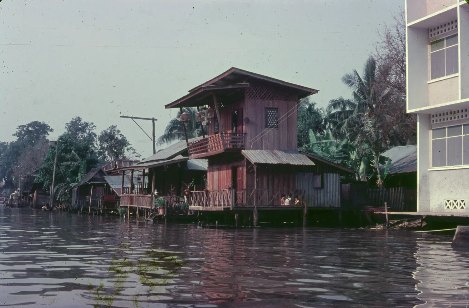 Riverside Stilt Houses Along a Southeast Asian Canal, 1965