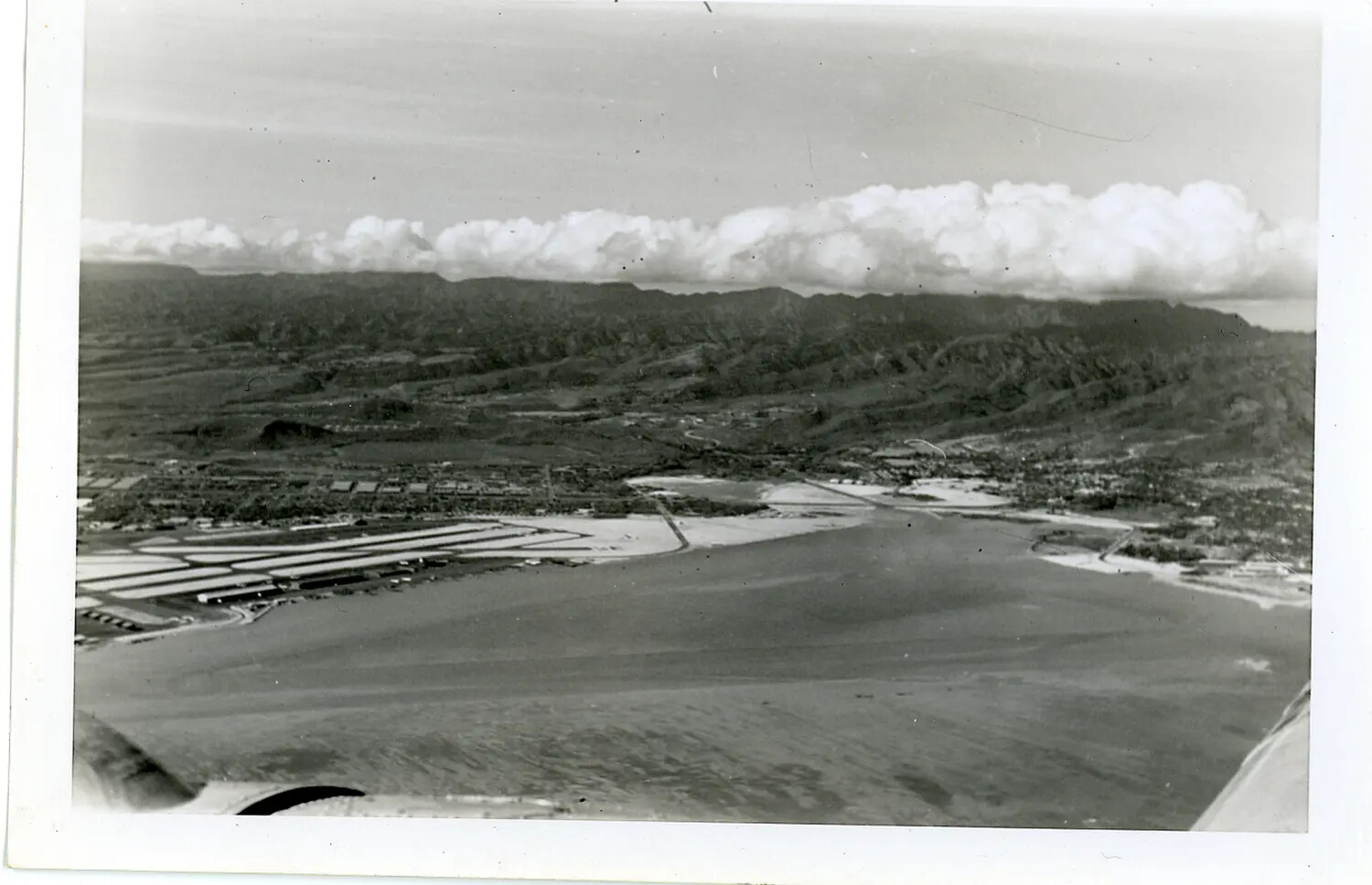 Aerial View of a Hawaiian Coastal Bay and Mountain Ridge, Taken from an Aircraft, WWII Era (Probable)