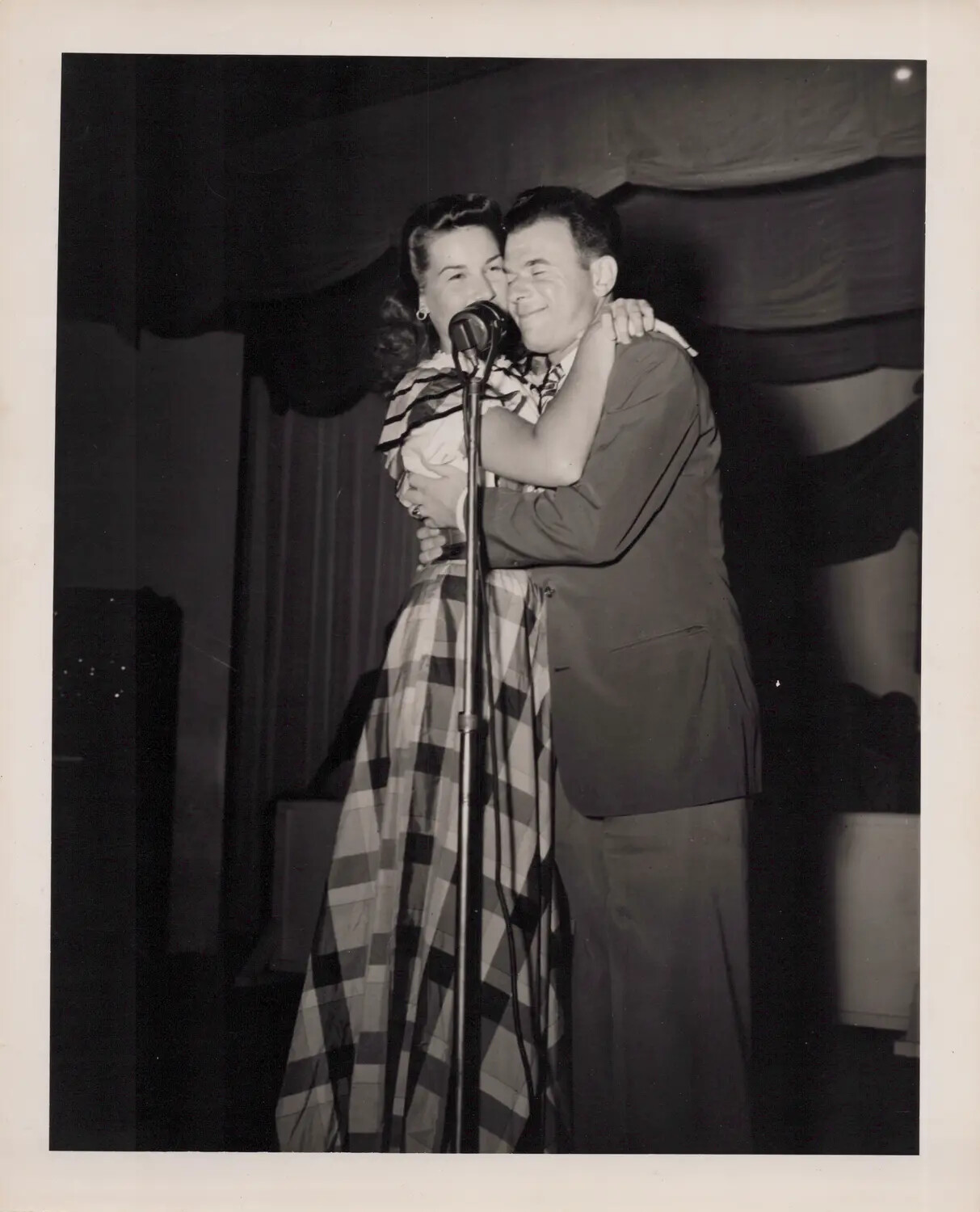 Performer and Master of Ceremonies Embracing at Microphone, WWII Era Variety Show