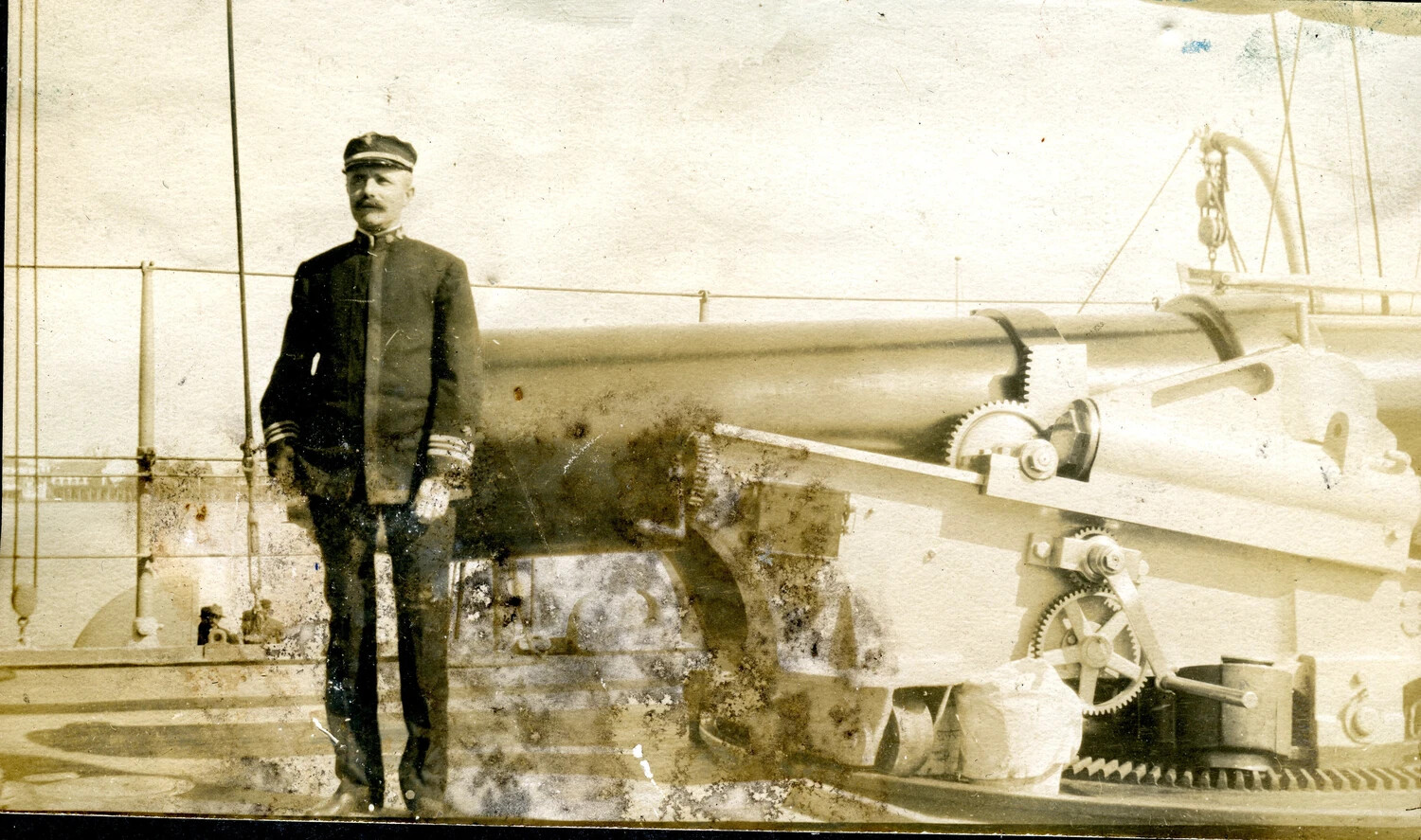 Naval Officer Posing Beside a 6-Inch Gun Mount Aboard USS Columbia (C-12), c. 1898-1907