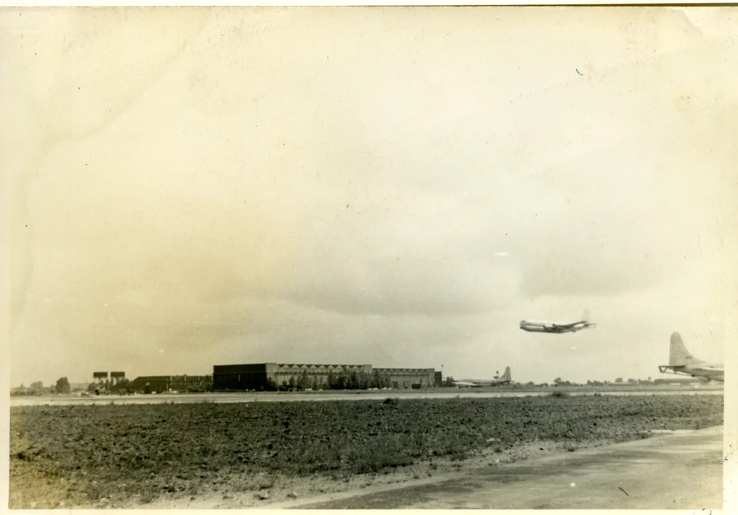 Airfield Panorama with Jet Bomber Departing and Propeller Bomber on Ramp, Early Cold War Era