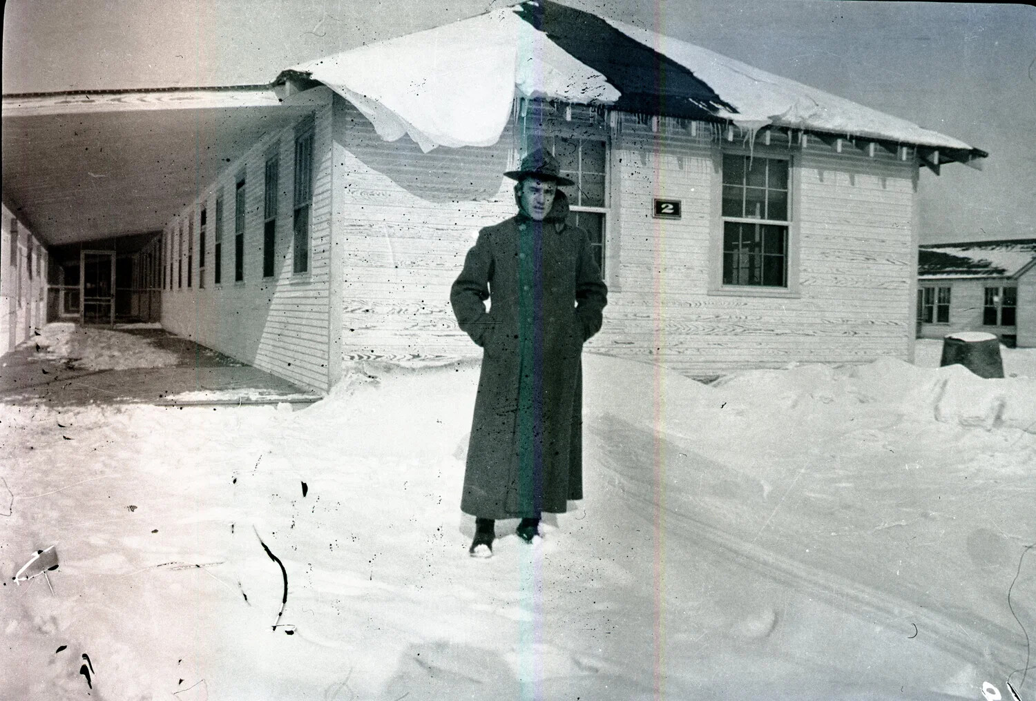 Soldier in Overcoat Before Snow-Covered Barracks, Scott Field Negative