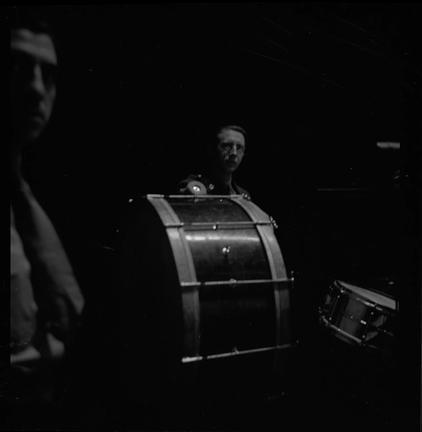 Bass Drummer with Marching Percussion Equipment, Military Band Rehearsal Setting