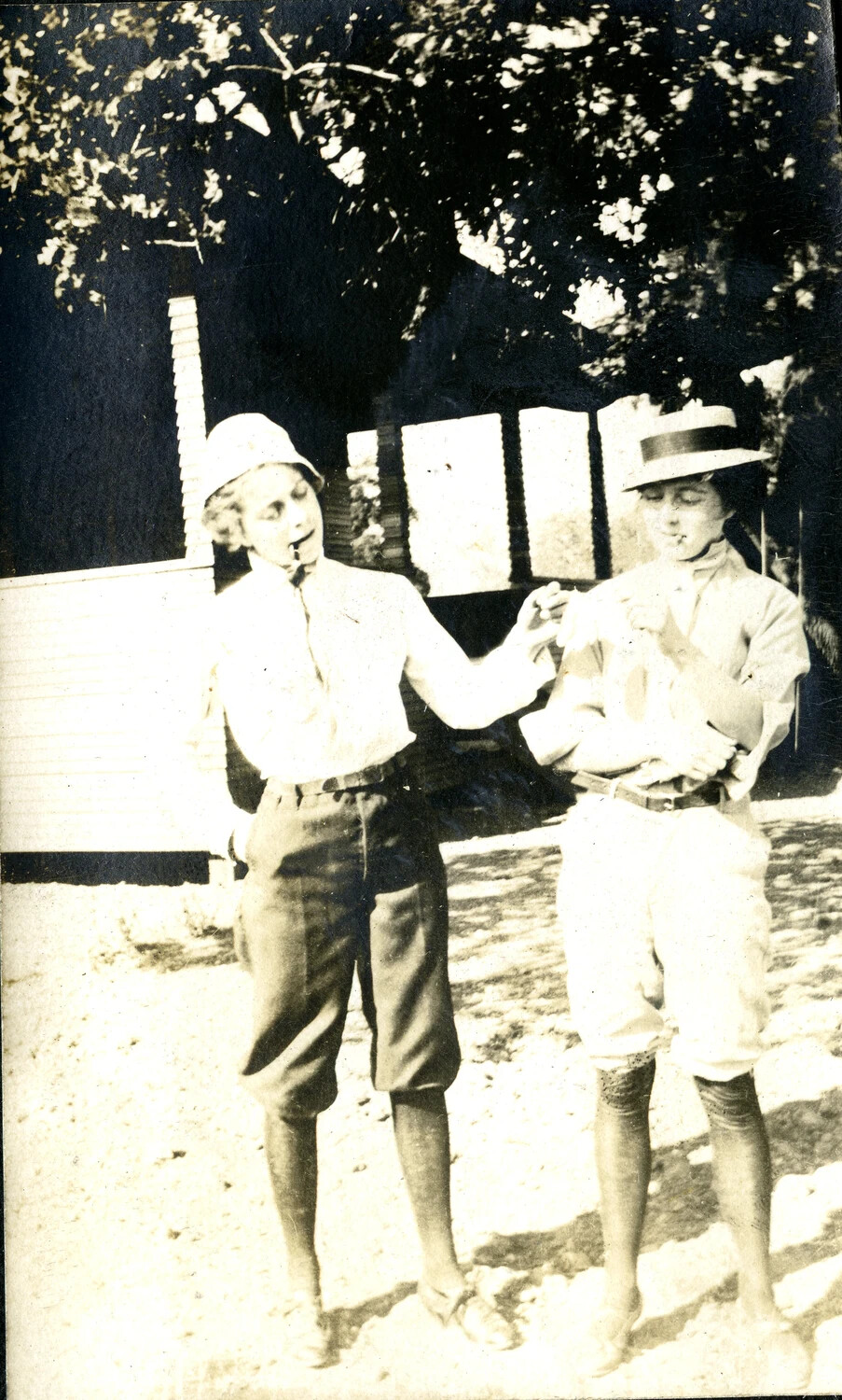 Two Young Women in Riding/Farm Attire Posed Together Outdoors, c. 1917-1919