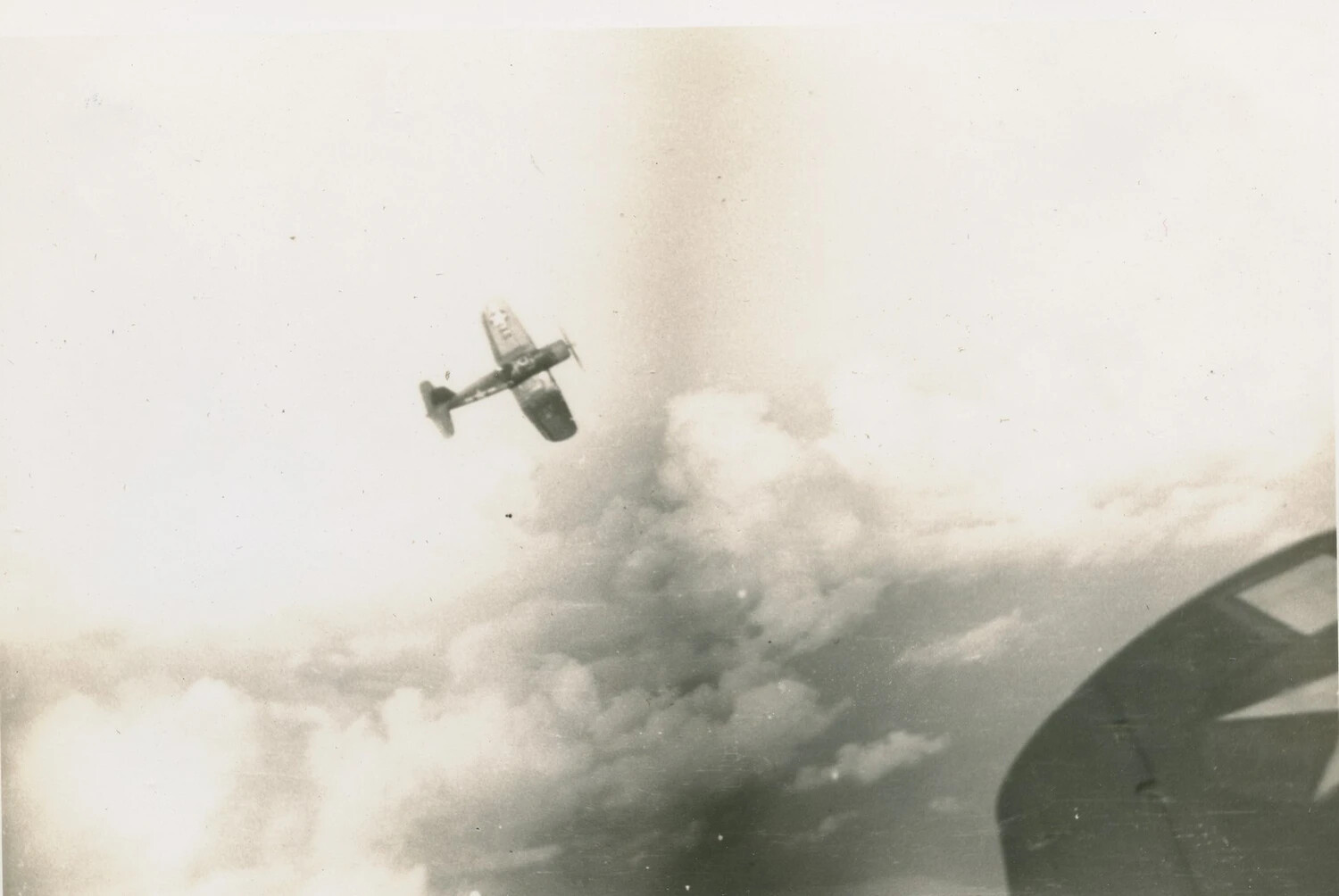 U.S. Navy Fighter Aircraft in Banking Flight Amid Clouds, WWII Air-to-Air Photograph