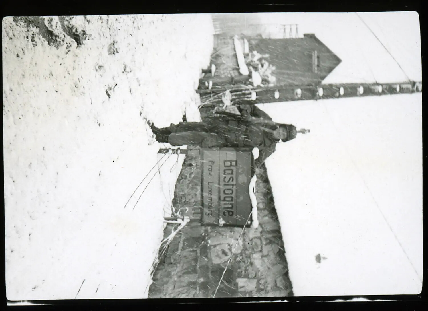 American Soldier at the Bastogne Town Sign During Heavy Snowfall, Belgium, December 1944