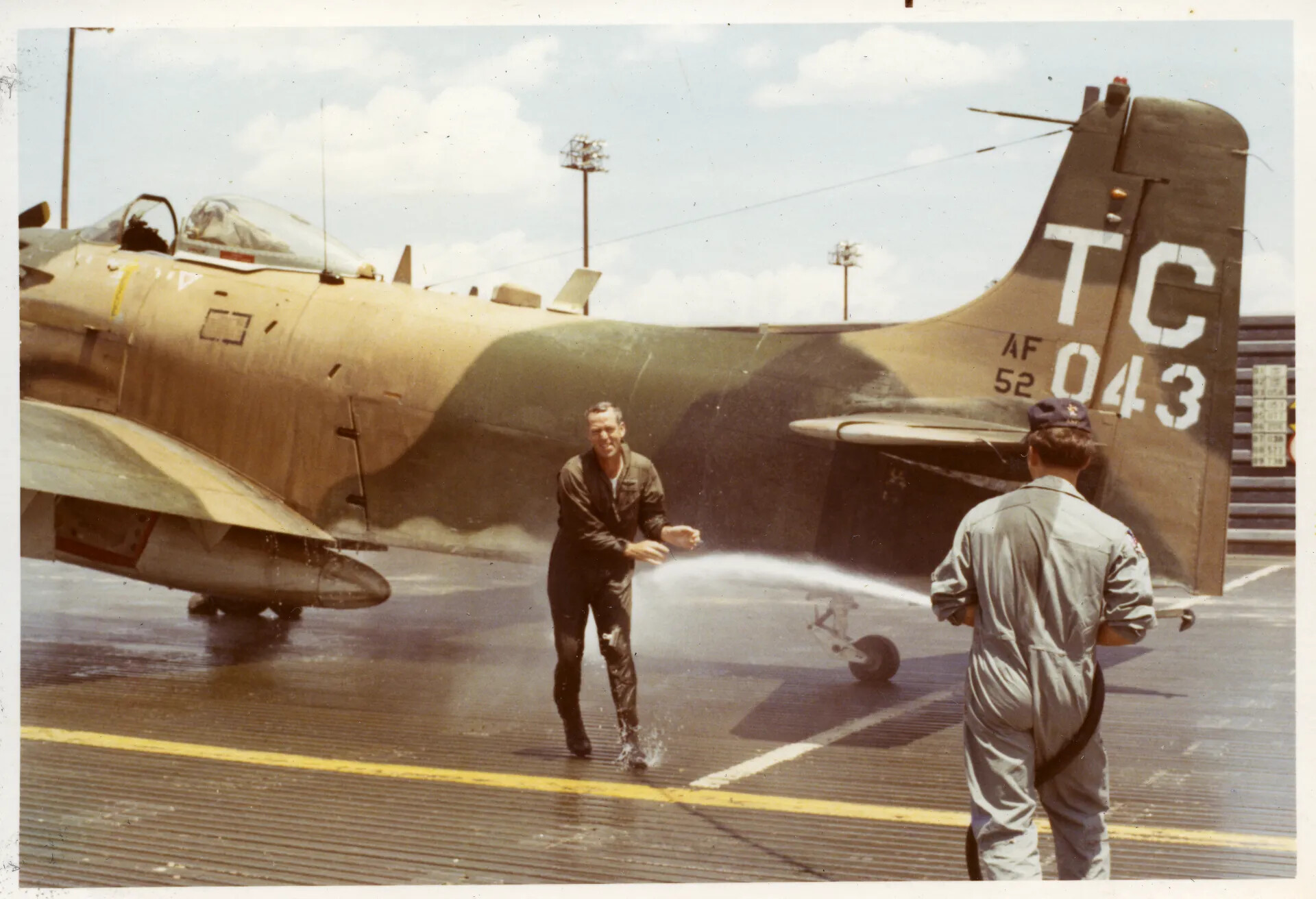 Pilot Hosed Down Beside A-1 Skyraider "TC 043", Nakhon Phanom RTAFB