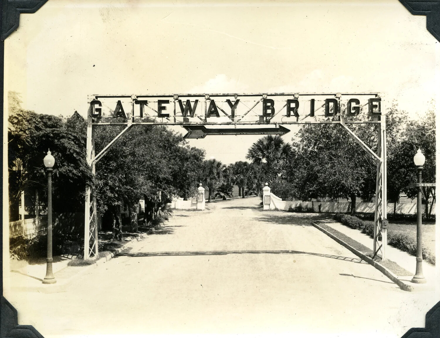 'Gateway Bridge' Illuminated Archway Sign Over Palm-Lined Street