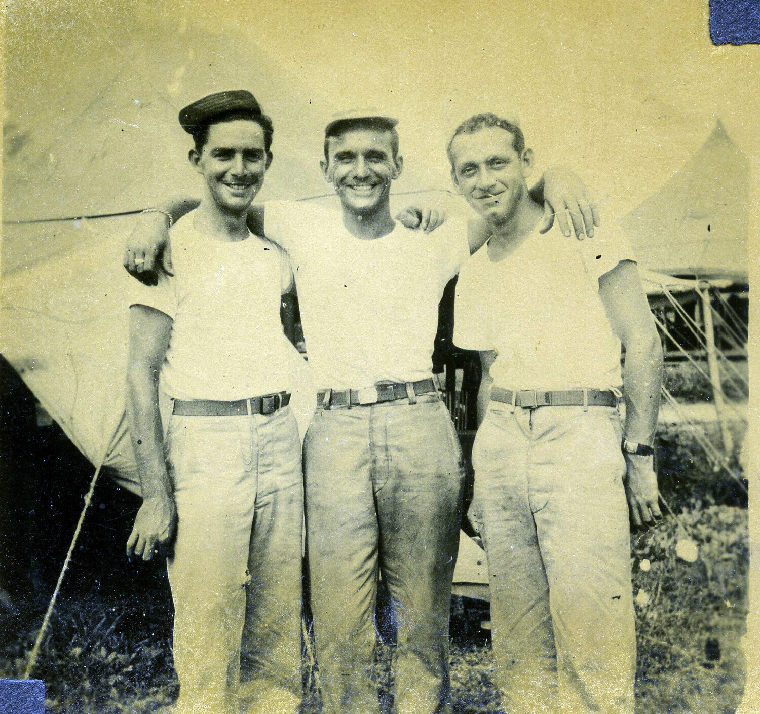 Three Airmen Posing Arm-in-Arm Before Squad Tents, 345th Bombardment Group, Pacific Theater, WWII