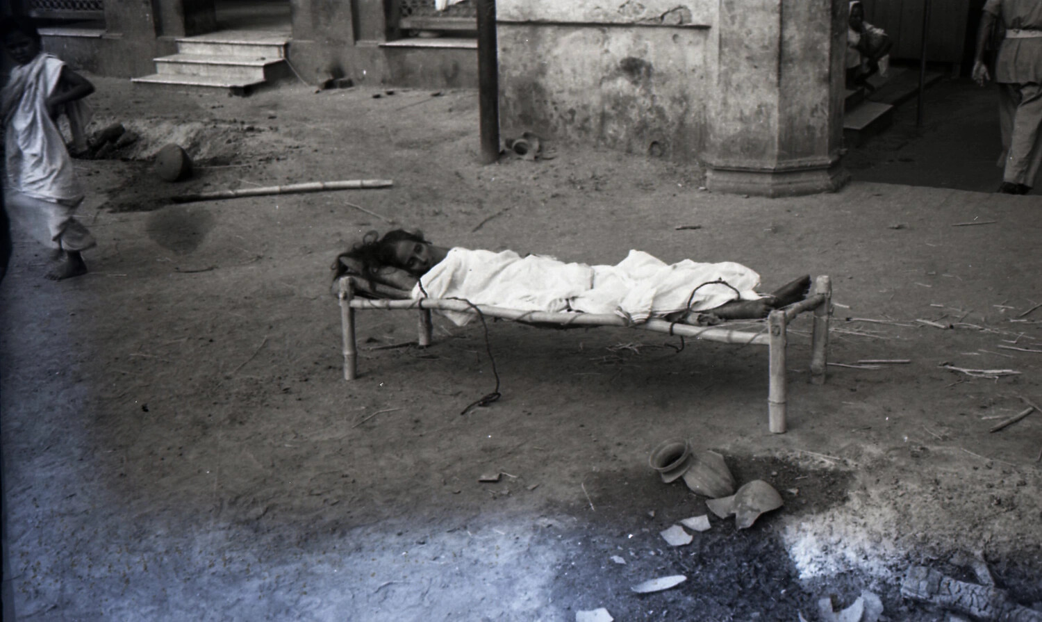Street Scene with Person Resting on a Charpoy, India, WWII China-Burma-India Theater