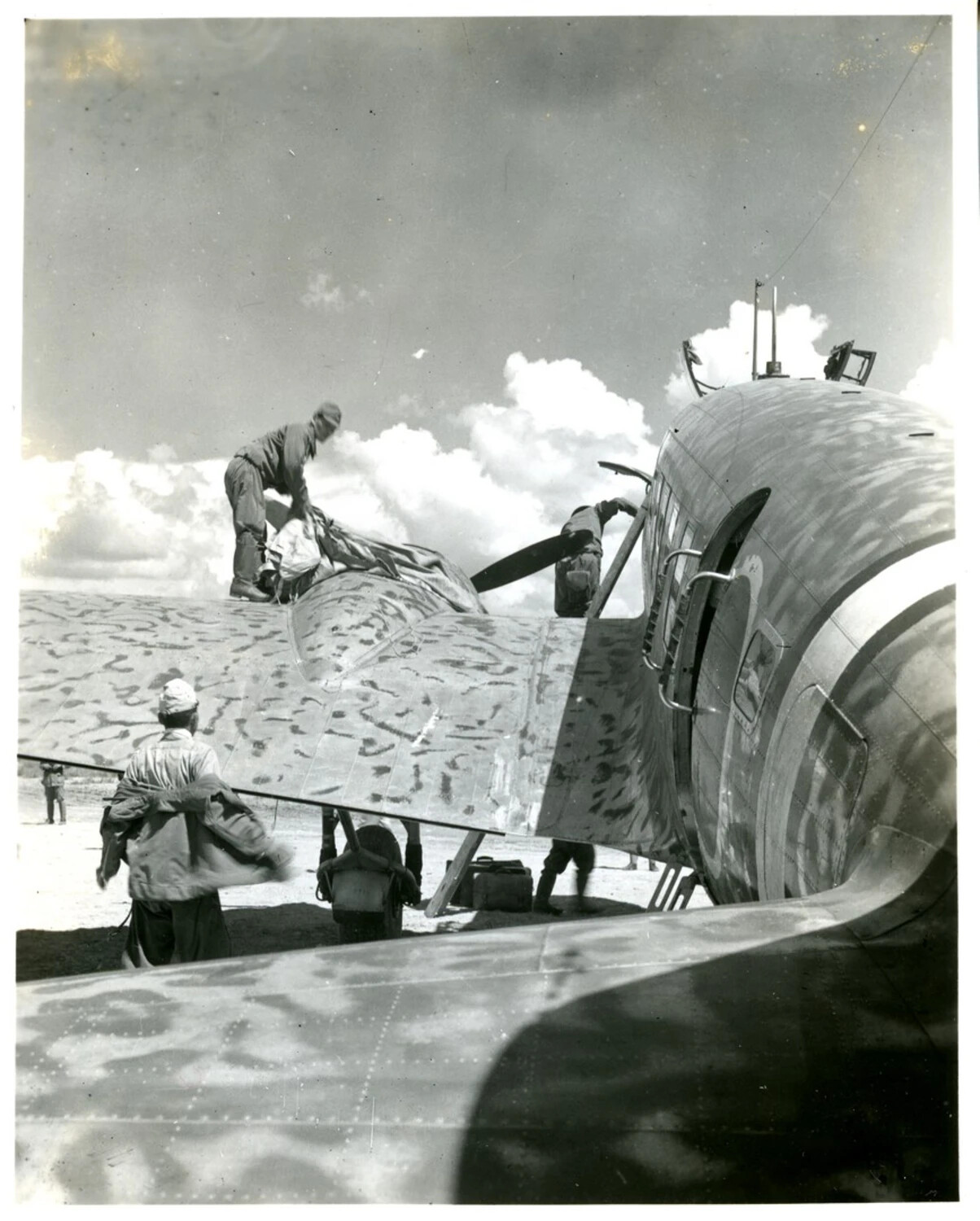 Ground Crew Servicing Camouflaged Transport Aircraft, CBI Theater, WWII