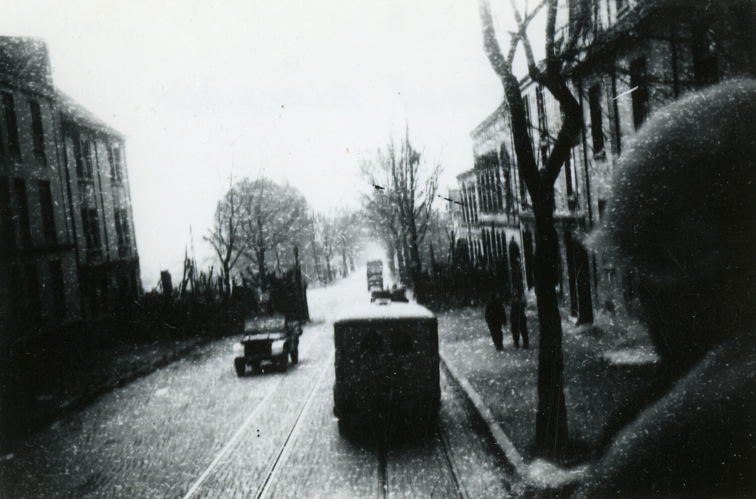 U.S. Army Convoy Moving Through a Snow-Covered European Town Street