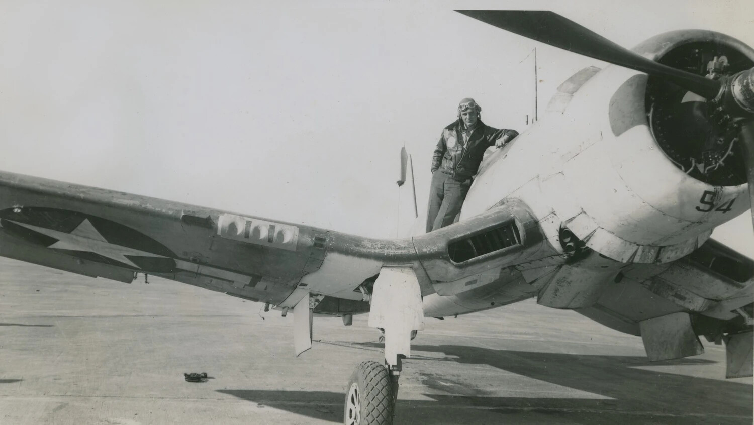 Marine Aviator Standing on Folded Wing of Fighter Aircraft, Side Number '94' (McAleer Collection)