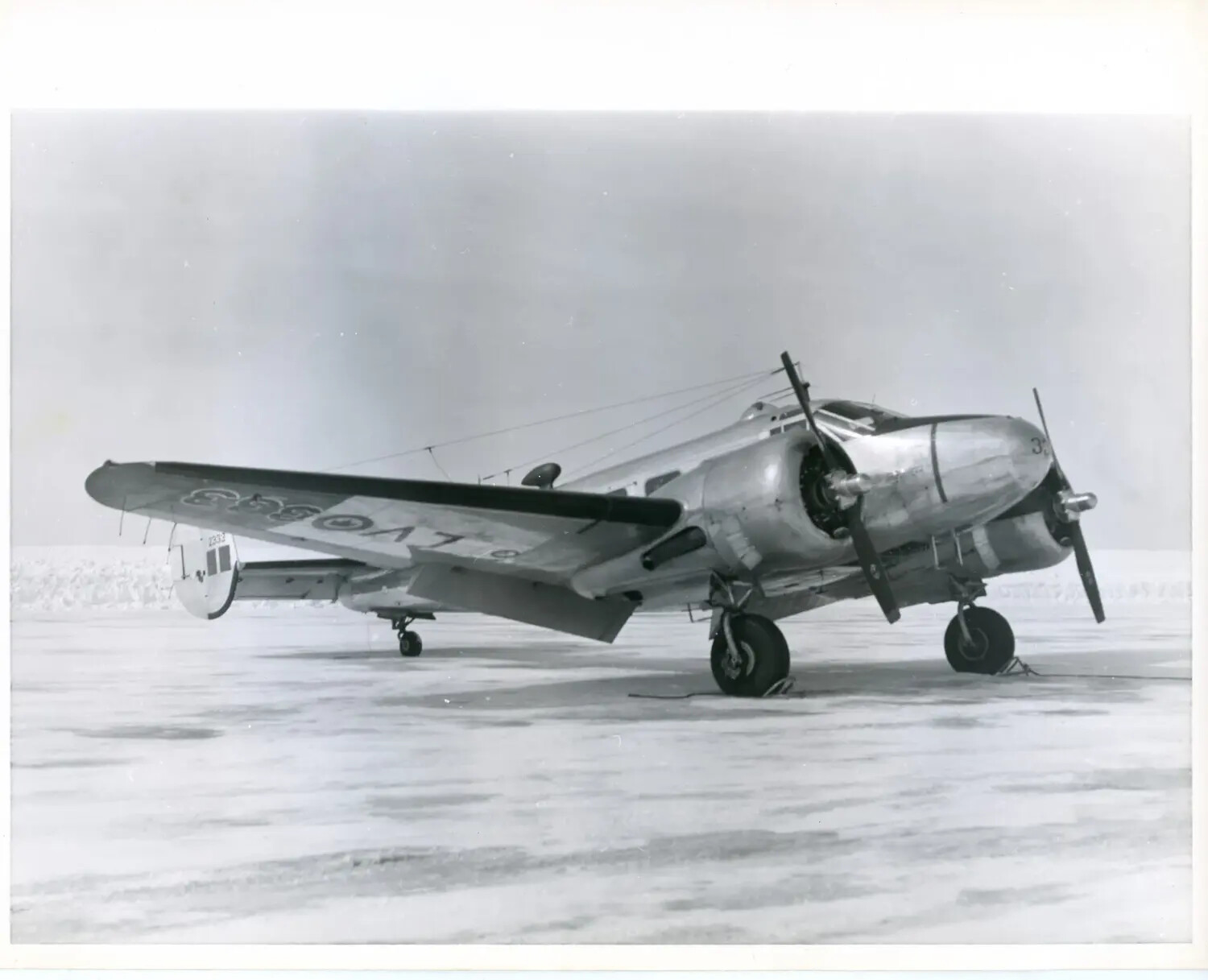 Twin-Engine Radial Military Trainer Aircraft on Snow-Covered Airfield, 1940s