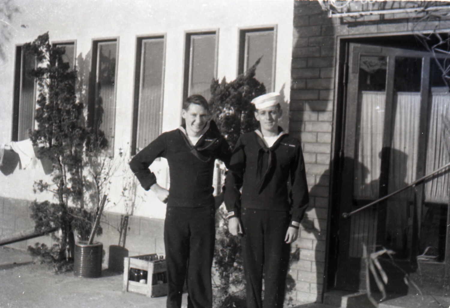 Two U.S. Navy Sailors in Dress Blues, likely Japan, early-to-mid 1950s