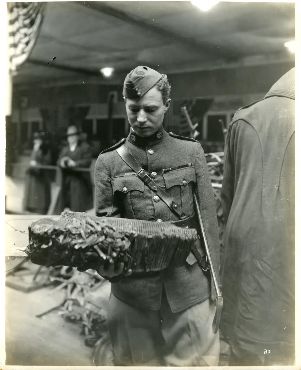 AEF Soldier Examining Wickerwork Aircraft Component at WWI Trophy Exhibit