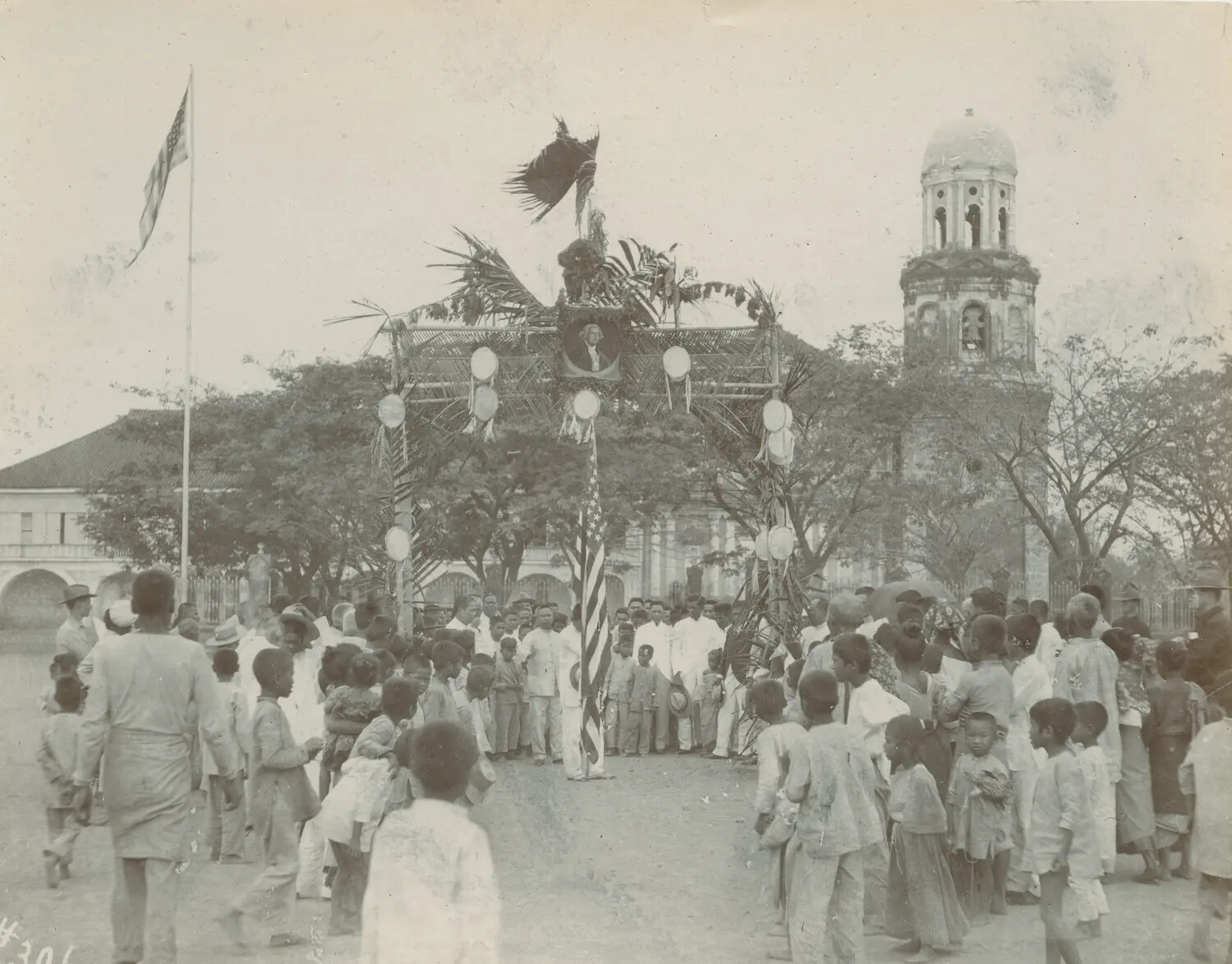 Ceremonial Arch and Crowd Gathering in Philippine Town Plaza, American Colonial Period