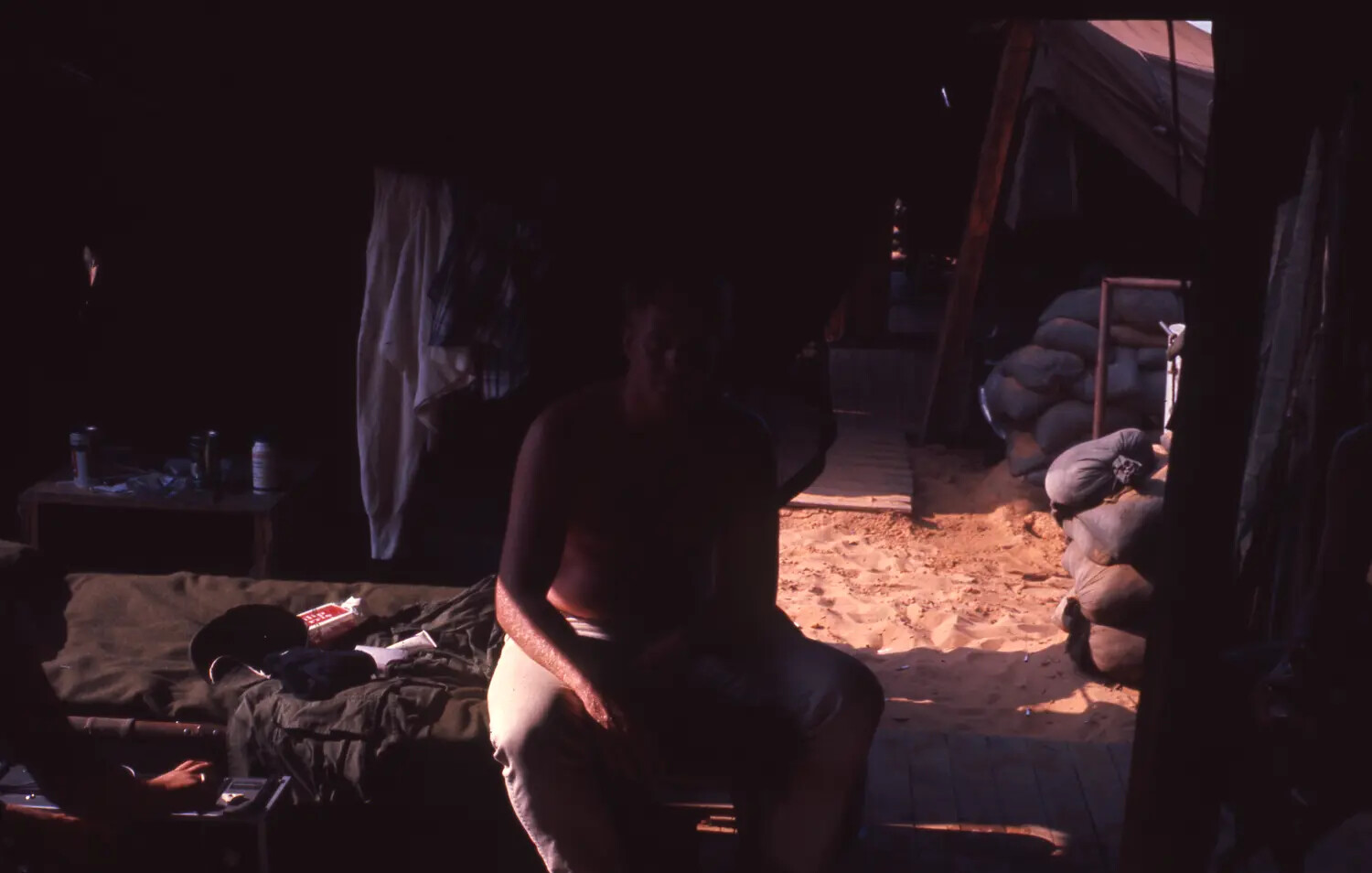 Vietnam War Era Color Slide: Silhouetted Serviceman Seated in Tent Quarters Near Sandbagged Bunker, Cam Ranh Bay, Vietnam