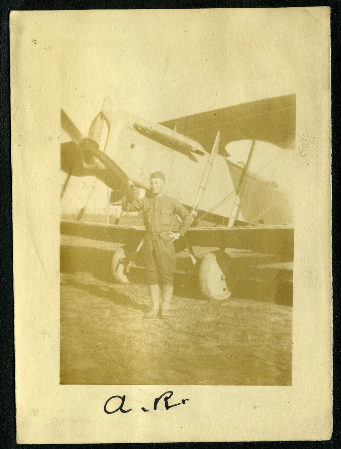 Serviceman Posing with a WWI-Era Biplane, France, World War I