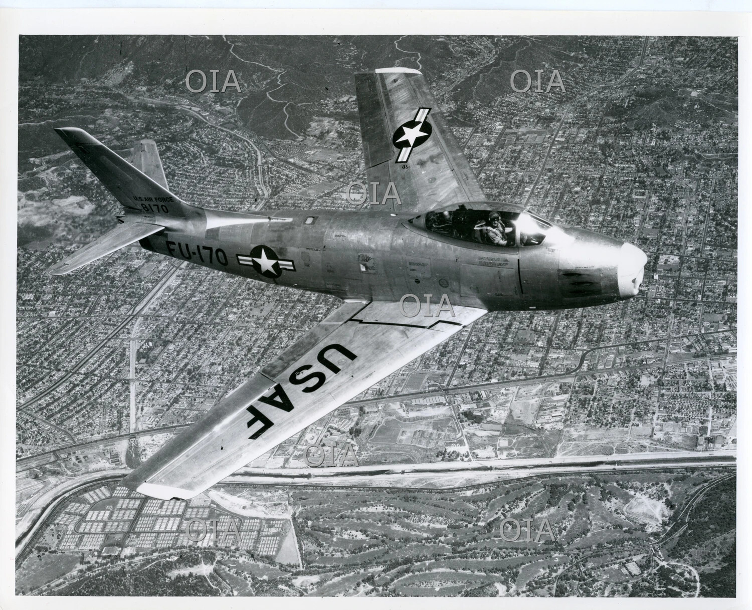 North American F-86 Sabre 'FU-170' (S/N 8170) Banking in Flight Over Urban Landscape