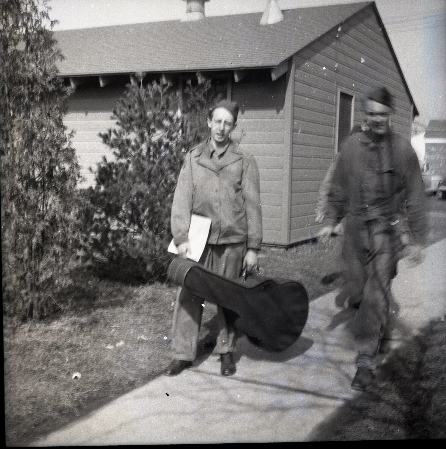 Military Band Members with Guitar Case Outside Barracks Building