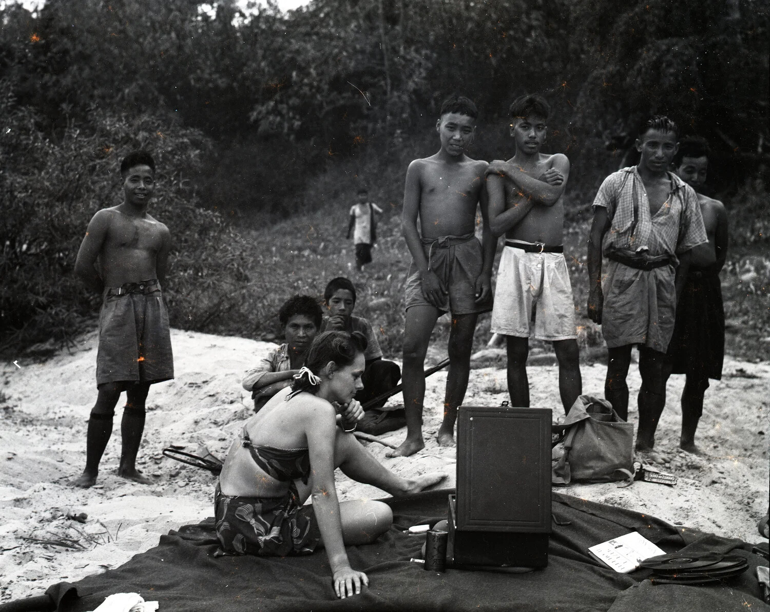 Western Woman with Portable Phonograph and Local Villagers on a Burma Riverbank, WWII CBI Theater