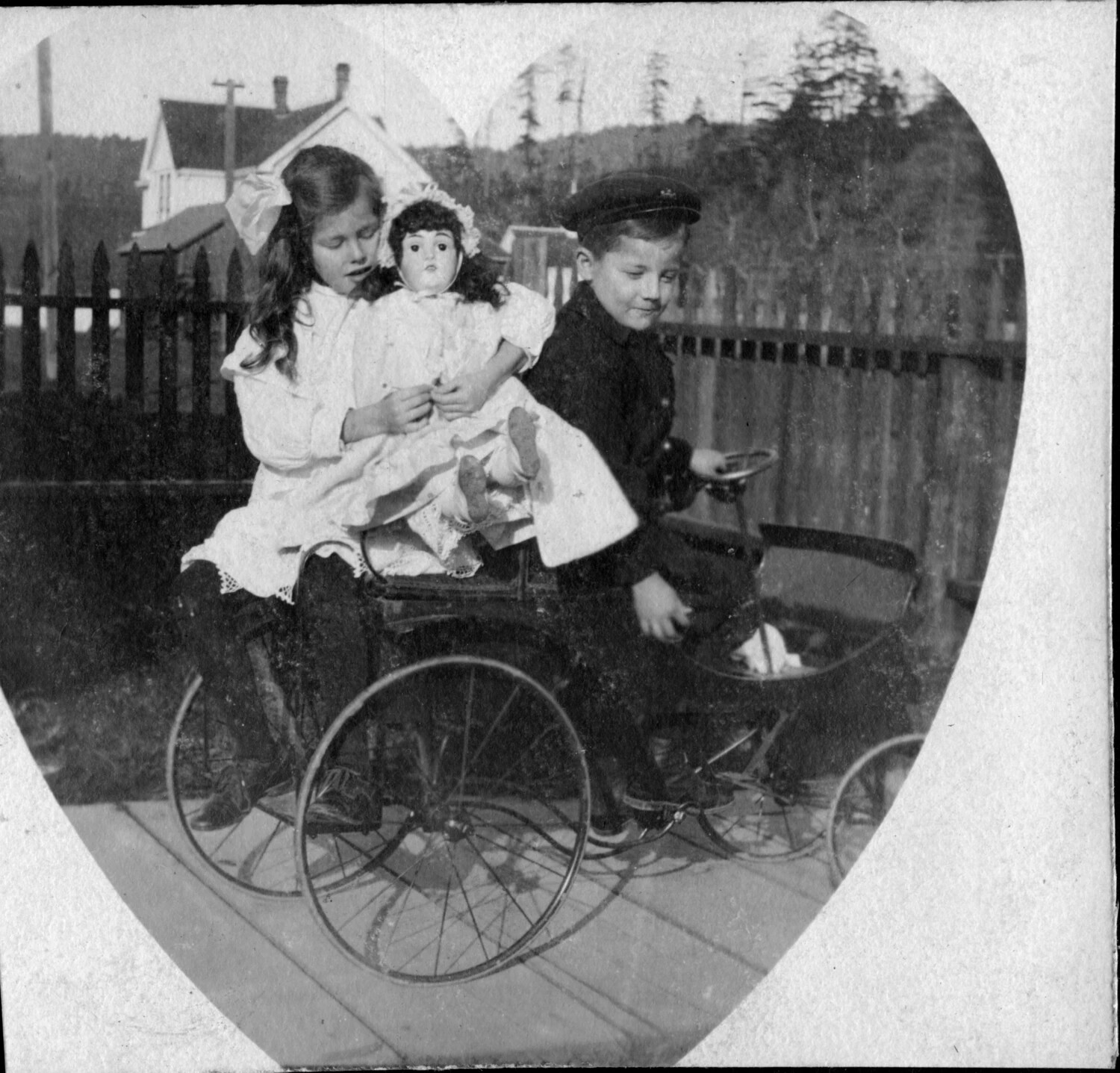 Two Children with a Bisque Doll on a Wicker Pony Cart -- Presidio Family Album, c. 1900-1910