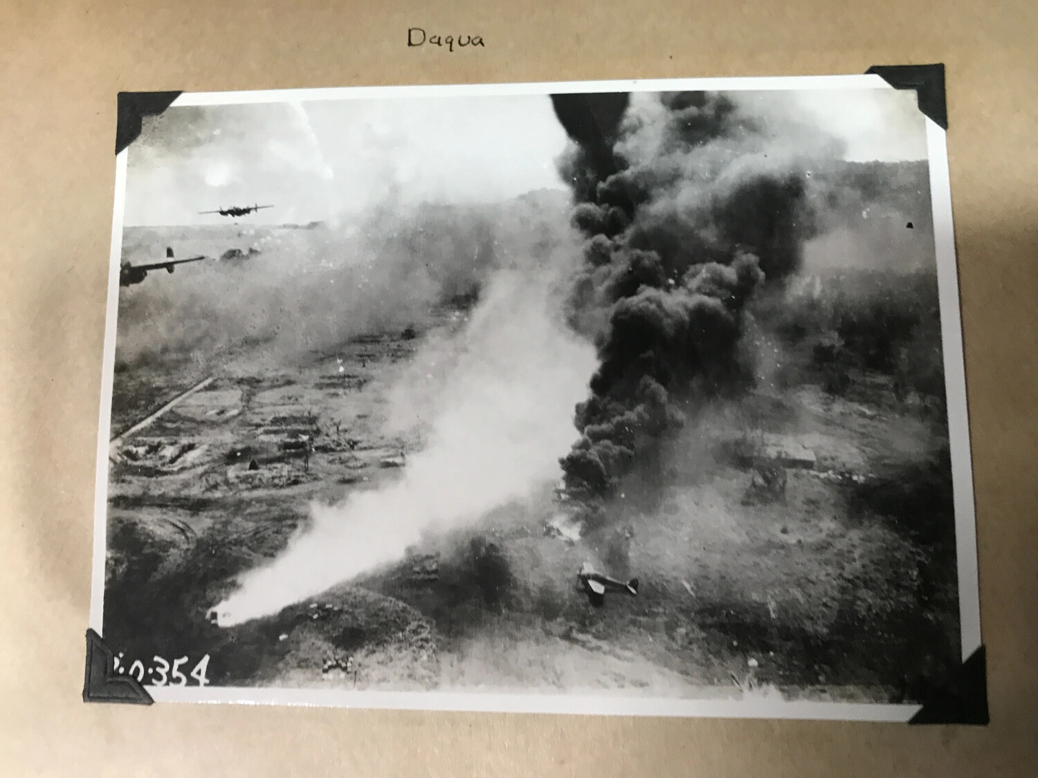Scrapbook Page No. 354: 'Daqua' -- B-25 Formation Beside Smoke Column