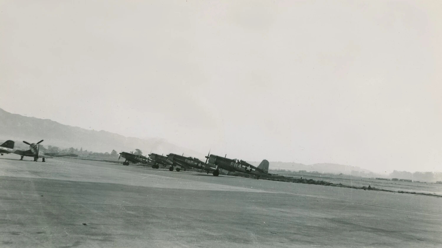 Line of Vought F4U/AU-1 Corsair Fighters on Airfield Ramp - Pat McAleer Collection, Korean War Era