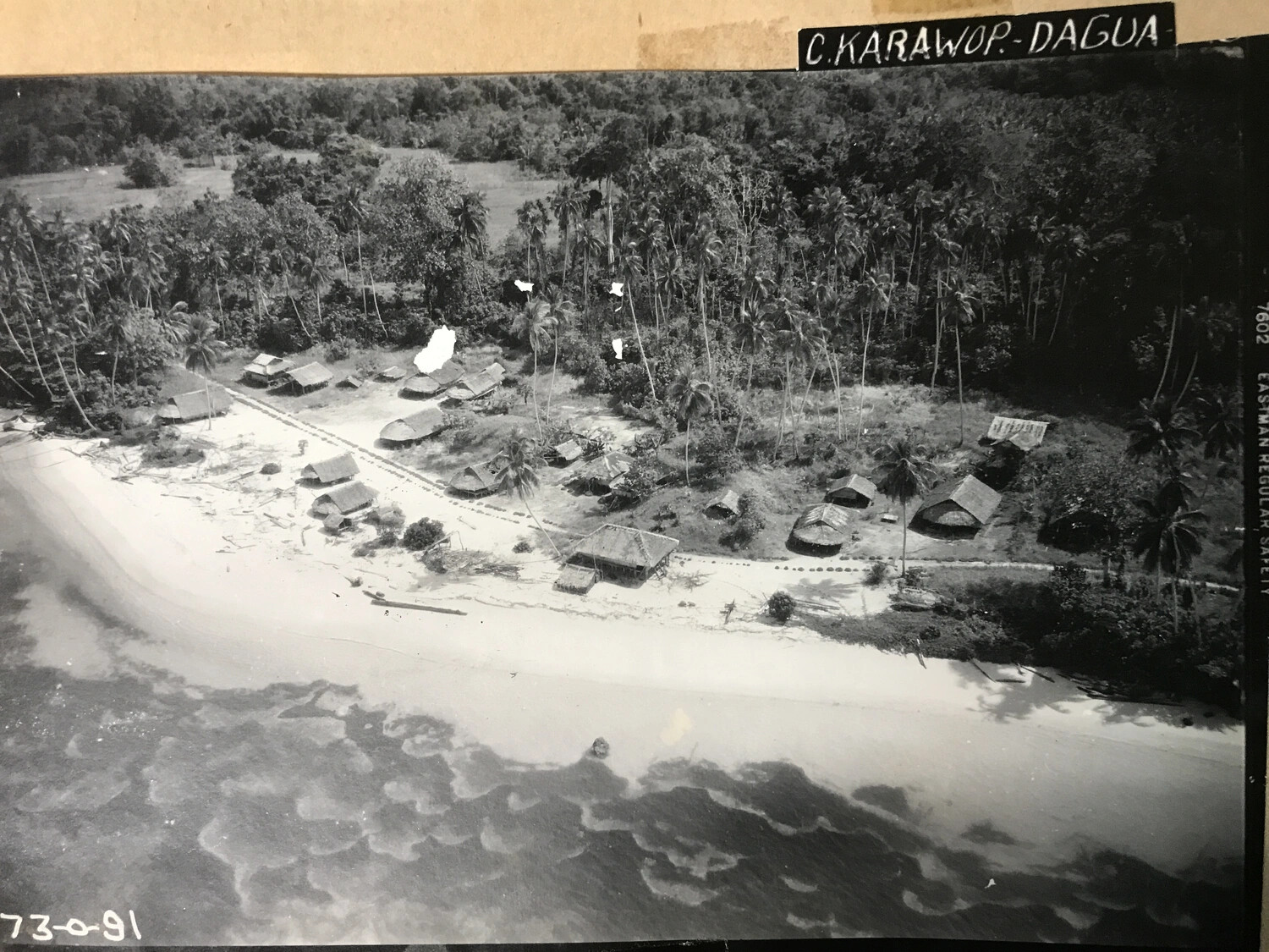 Aerial Oblique Photograph of Native Village with Film Edge Markings, Cape Karawop-Dagua, New Guinea