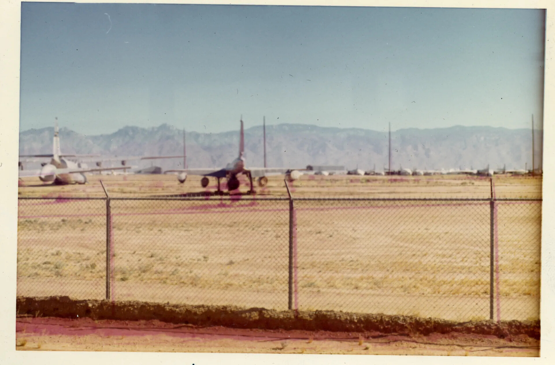 Parked Military Aircraft at a Desert Airfield, Possibly Davis-Monthan AFB Boneyard