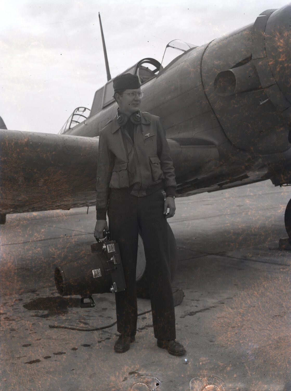 Airman with Equipment Case Beside Trainer Aircraft, China-Burma-India Theater — WWII (Damaged Negative)