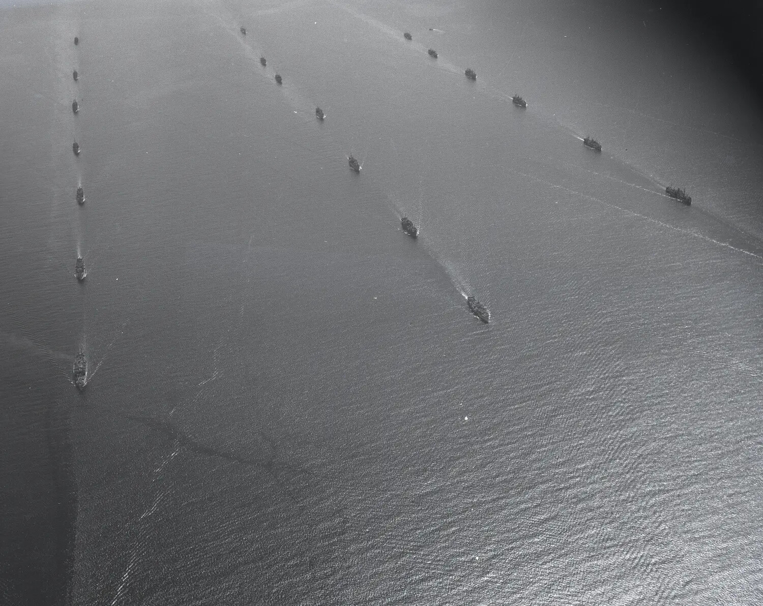 Aerial View of Naval Task Force/Convoy Underway in Formation, Pacific Theater (WWII era, possibly associated with USS Petrof Bay CVE-80)