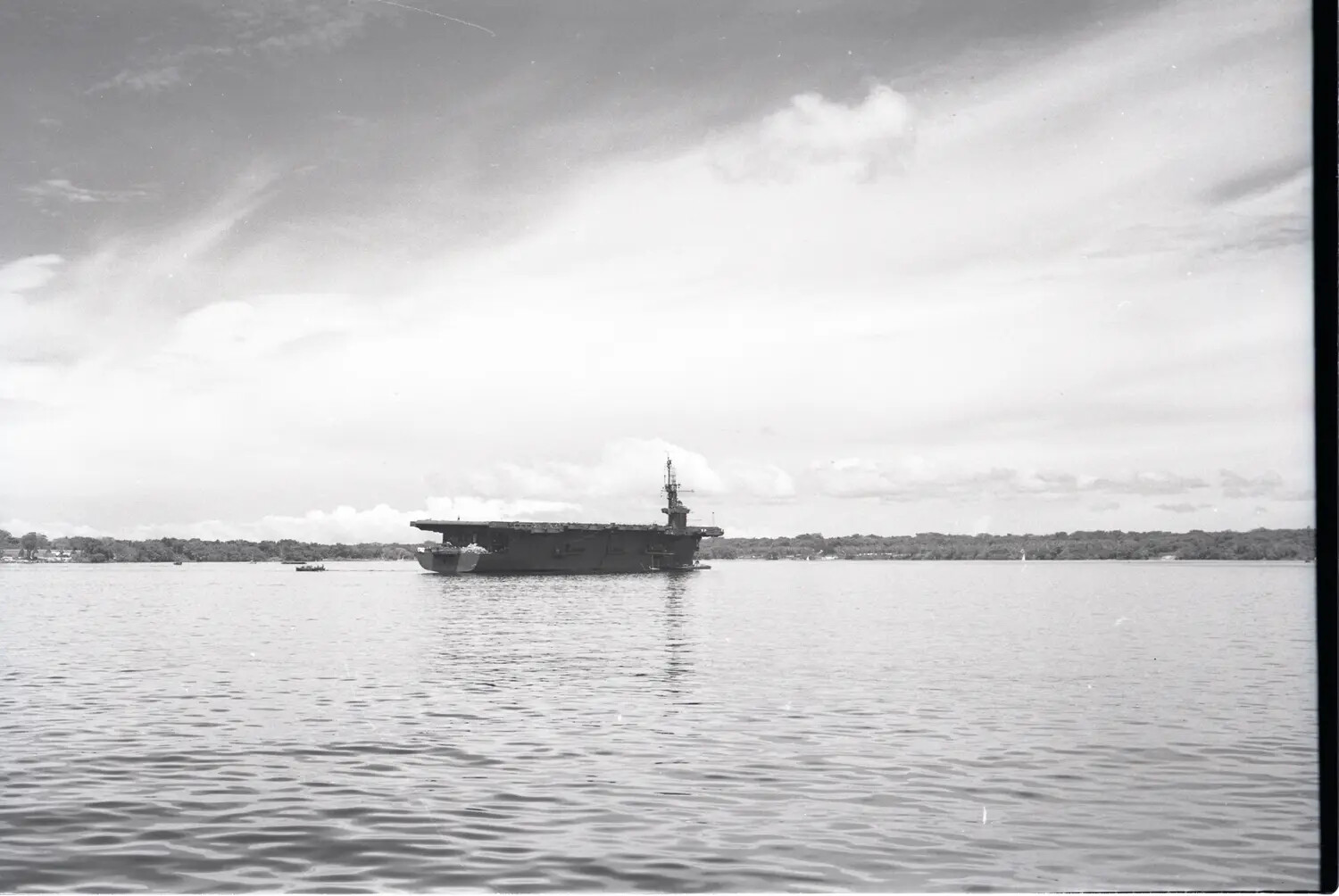USS Petrof Bay (CVE-80) at Anchor on Calm Inland Waters, Postwar or Late-War Era