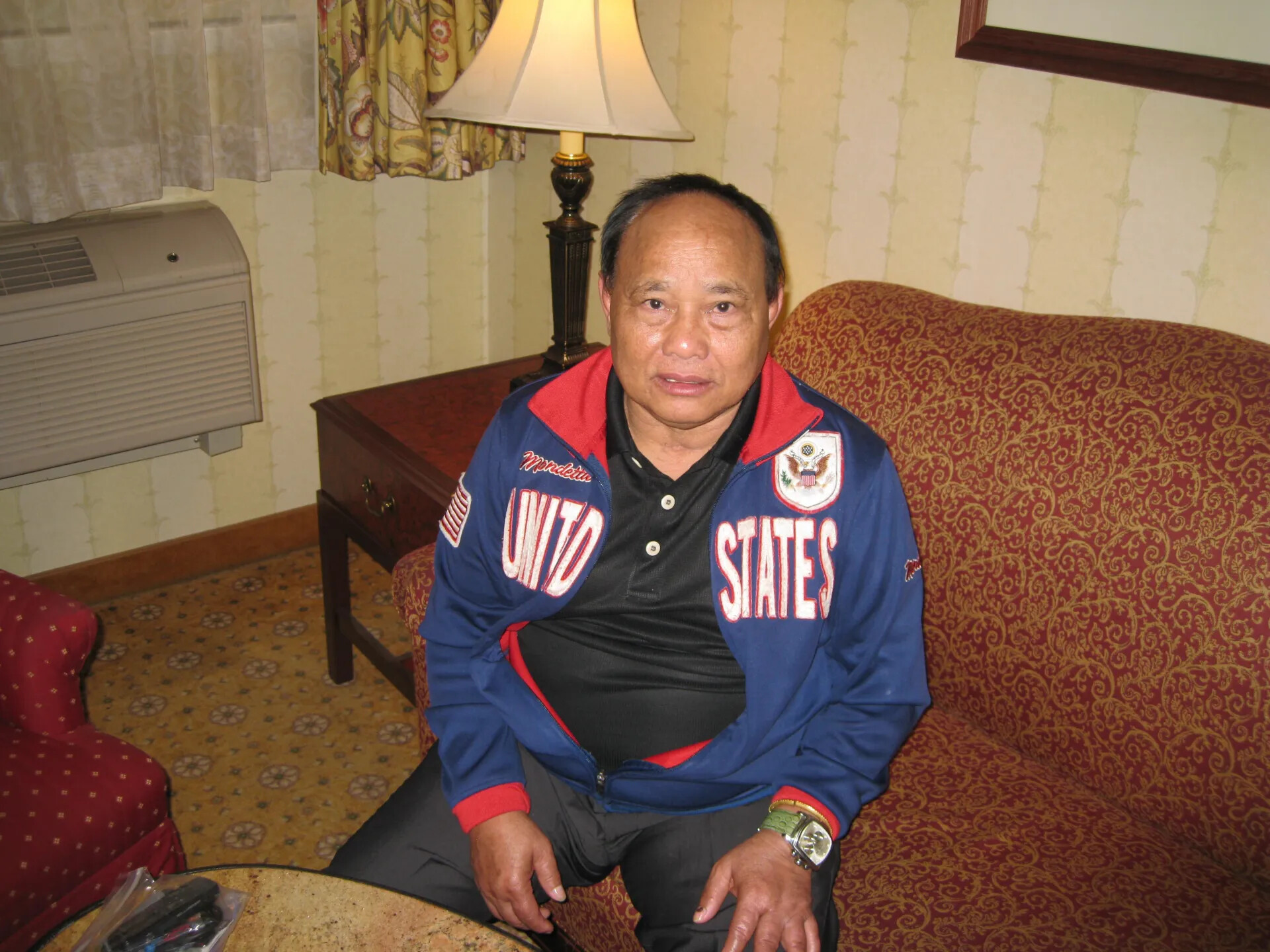 Seated Man in United States Track Jacket, Hotel Guest Room, Special Operations Association Reunion, 2013