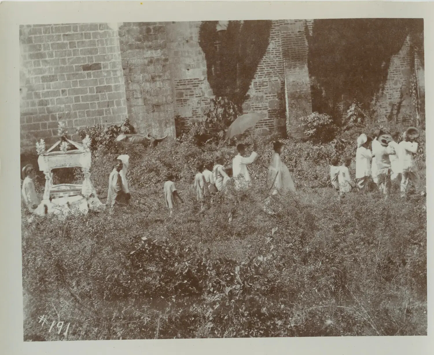Filipino Children and Adults Near Ruined Wall with Processional Bier, Philippines, Early 1900s