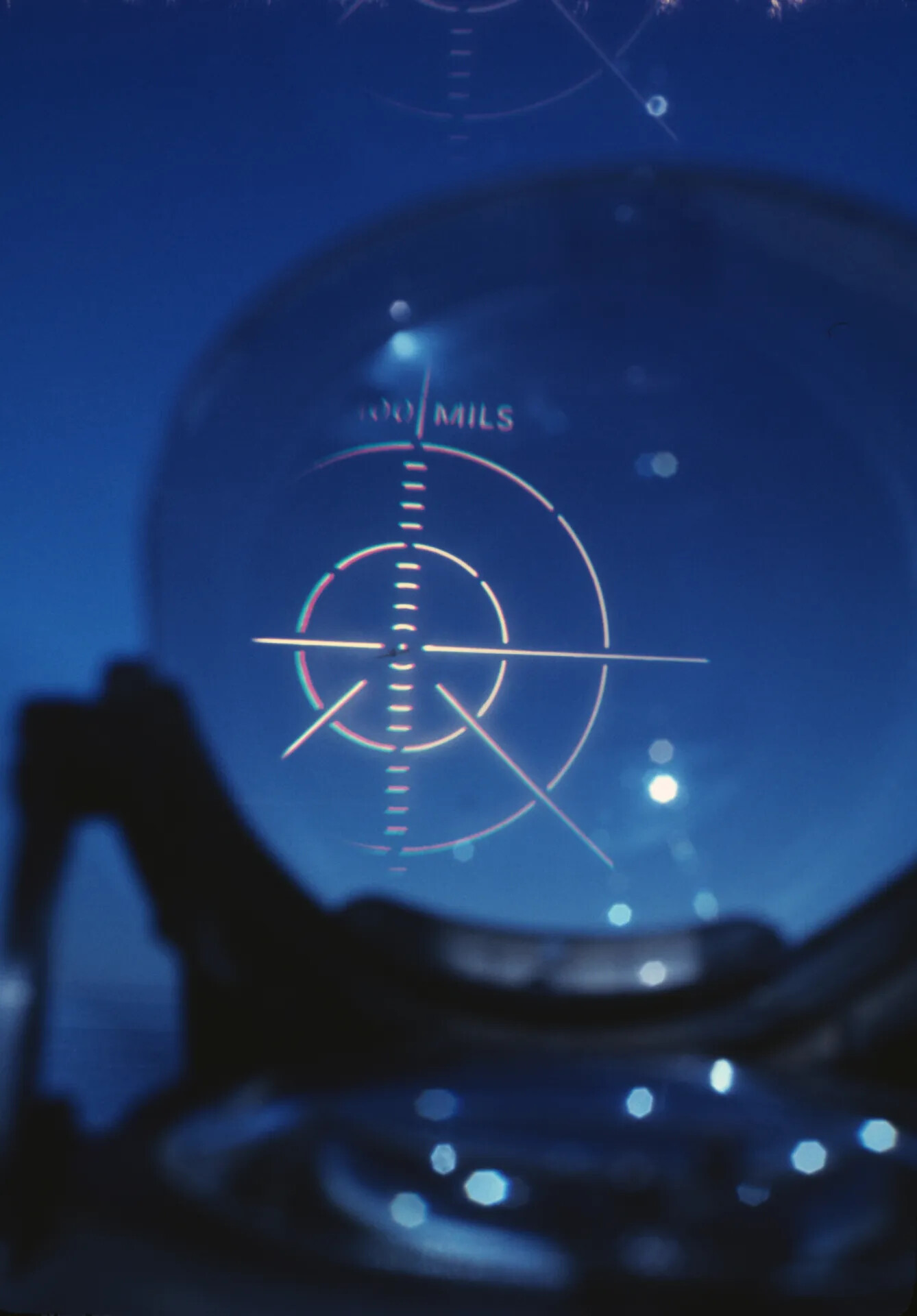 Aircraft Optical Gunsight Reticle at Dusk, Viewed Through Cockpit Windscreen
