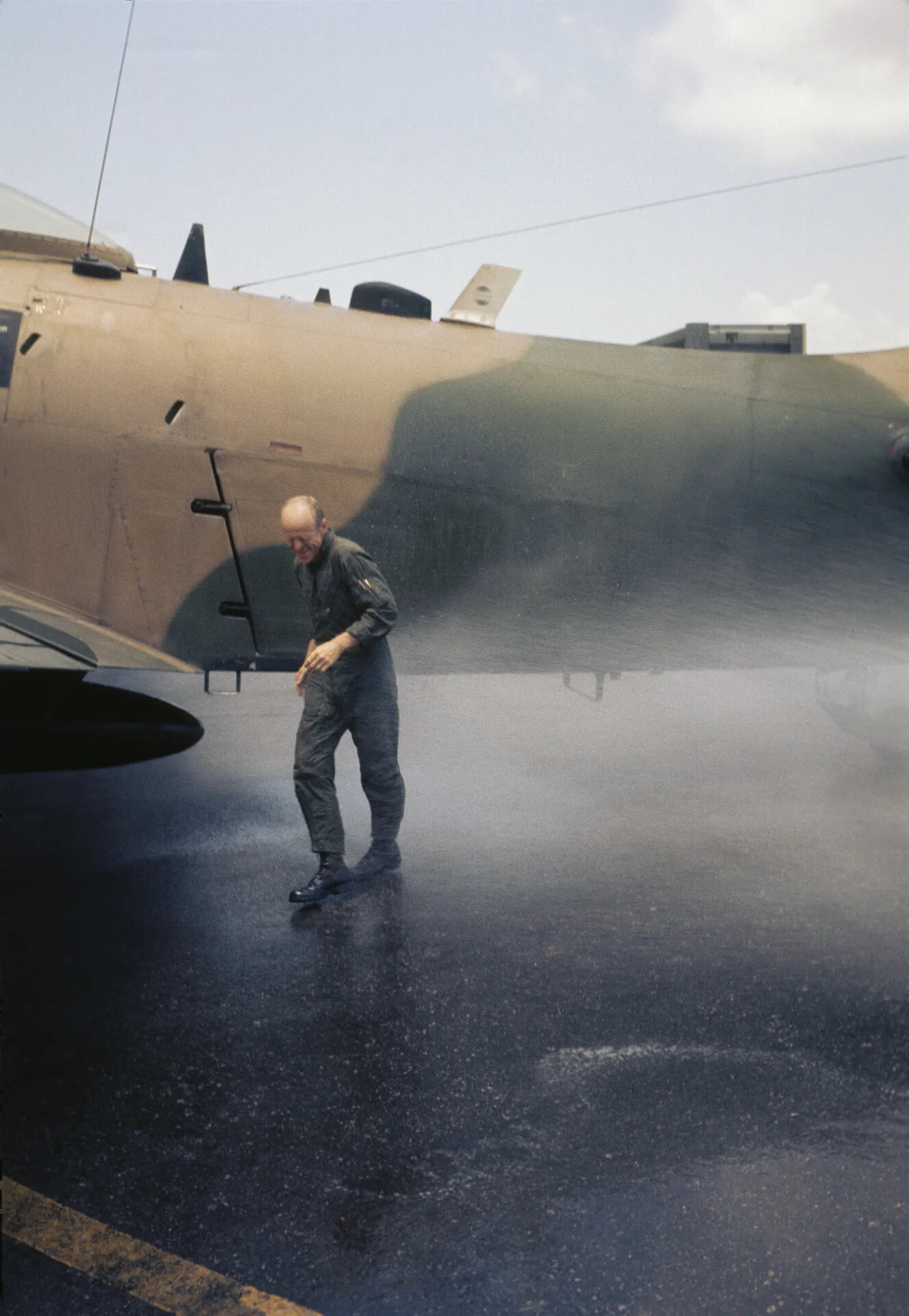 USAF Officer on Wet Flight Line Ramp Beside Large Aircraft, Don Engebretsen Collection