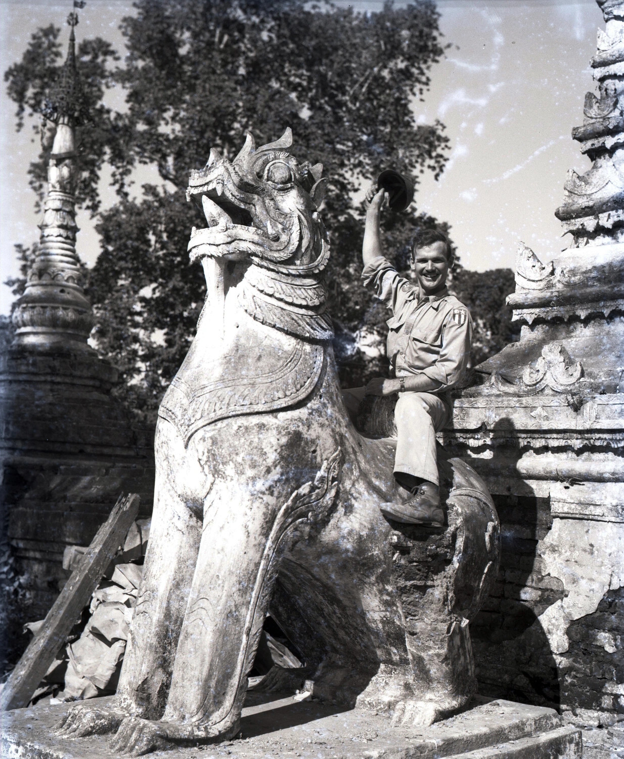 American Serviceman Atop a Chinthe Statue at a Pagoda, Myitkyina, Burma, WWII CBI Theater