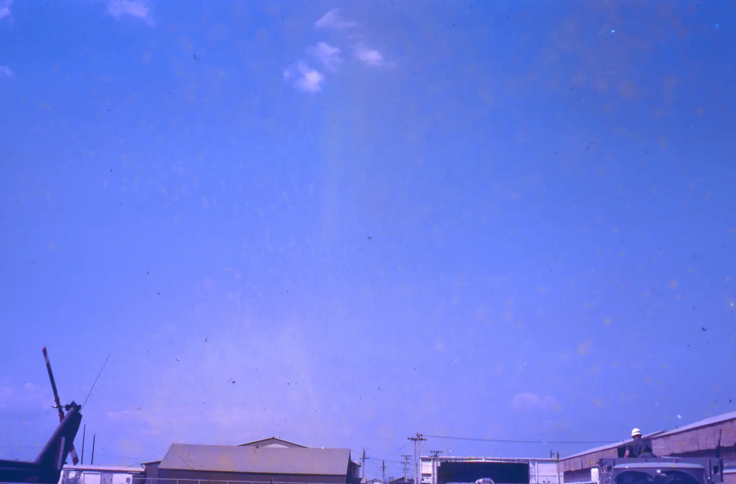 Airbase Rooftops and Helicopter Tail Boom Under Open Sky, Vietnam, 1968 Tet Offensive