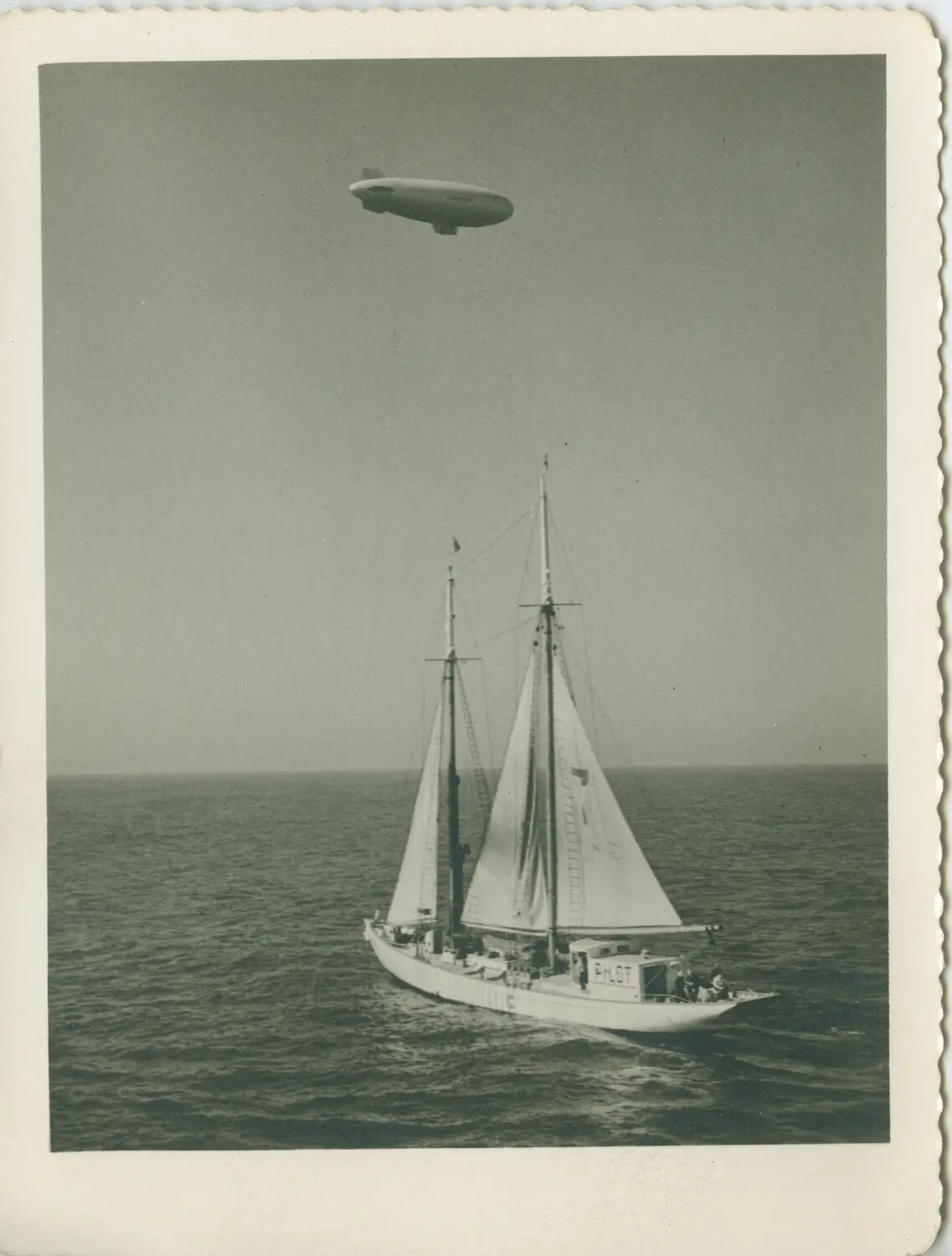 US Navy Patrol Blimp Over Two-Masted Pilot Boat 'Pilot,' WWII Era (USS Petrof Bay CVE-80 Collection)