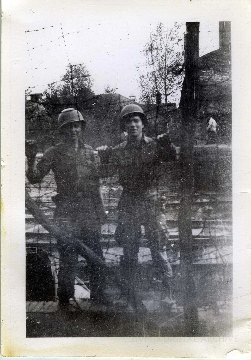 Two 101st Airborne Paratroopers at a Fenced Installation, Germany, Spring 1945