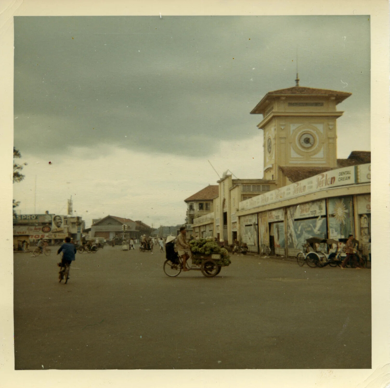 Ben Thanh Market Clock Tower with Vendor Cyclist and Street Traffic, Saigon, South Vietnam, 1964