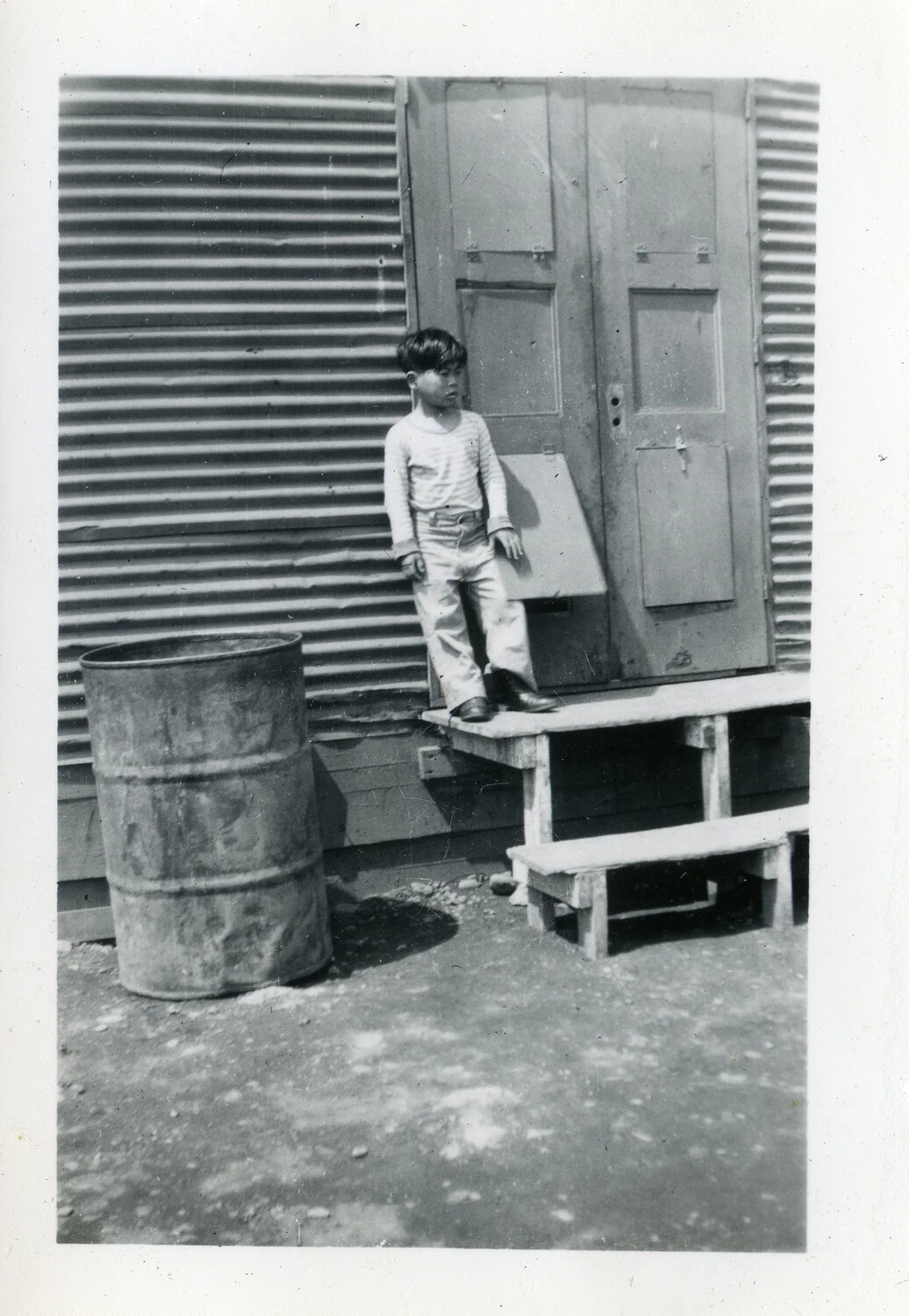 Filipino Boy Outside a Corrugated-Iron Building, Manila Area, Philippines