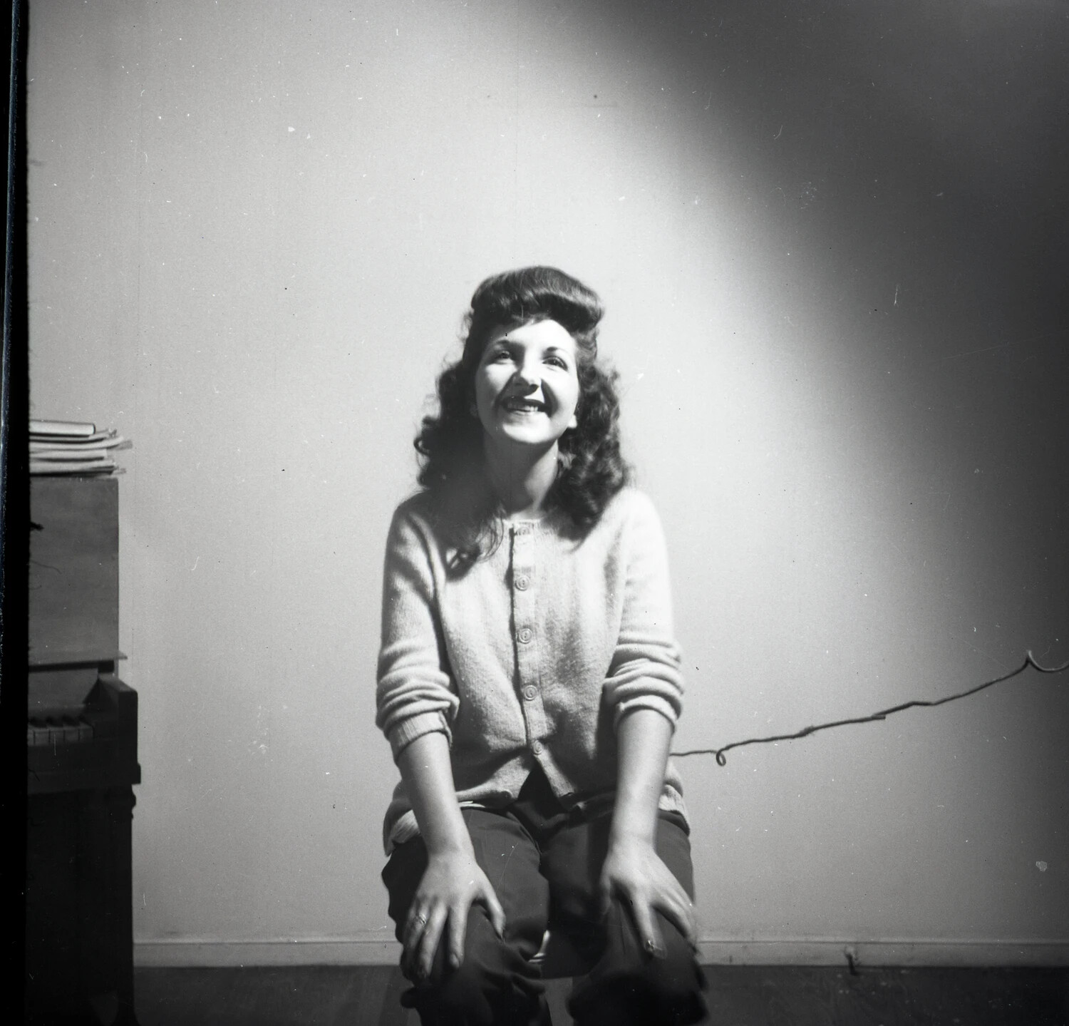 Young Woman Laughing in a Domestic Interior Near a Piano