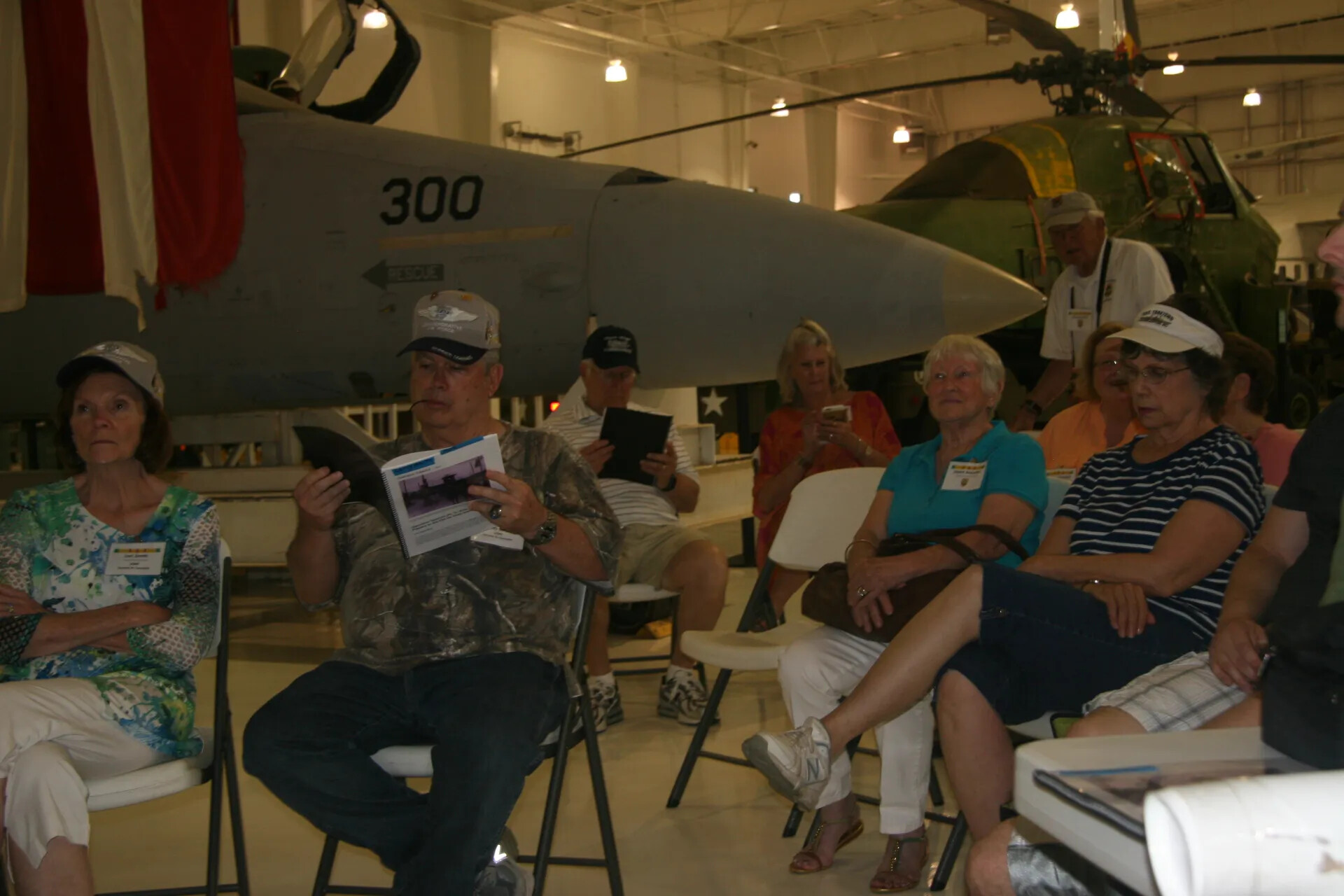 Reunion Attendees Seated Before Museum Aircraft Display, Operation Tailwind Event
