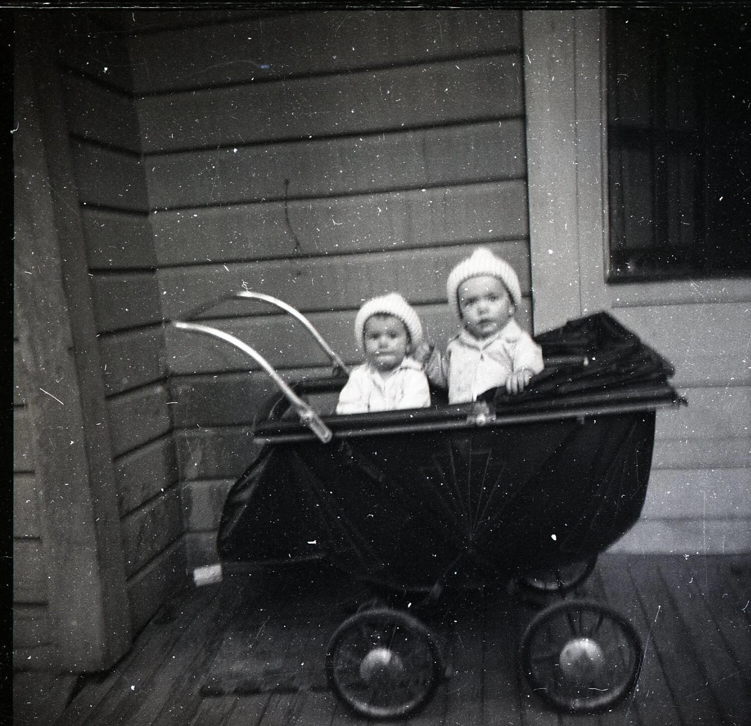 Two Children in a Twin Baby Carriage on a Porch, Jack T. Kelley Family Album