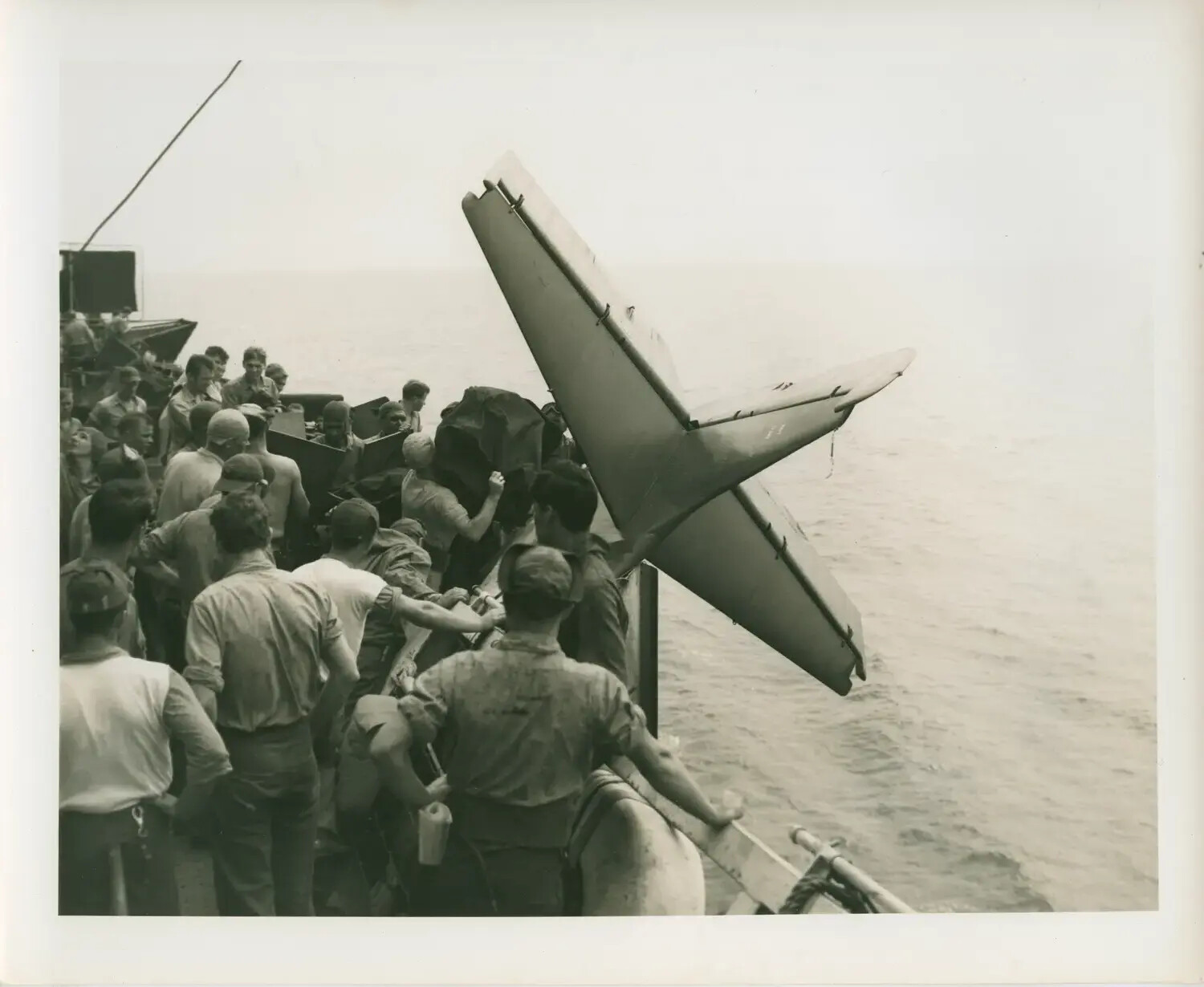 Crew Jettisoning Aircraft Tail Assembly Overboard, USS Petrof Bay (CVE-80)